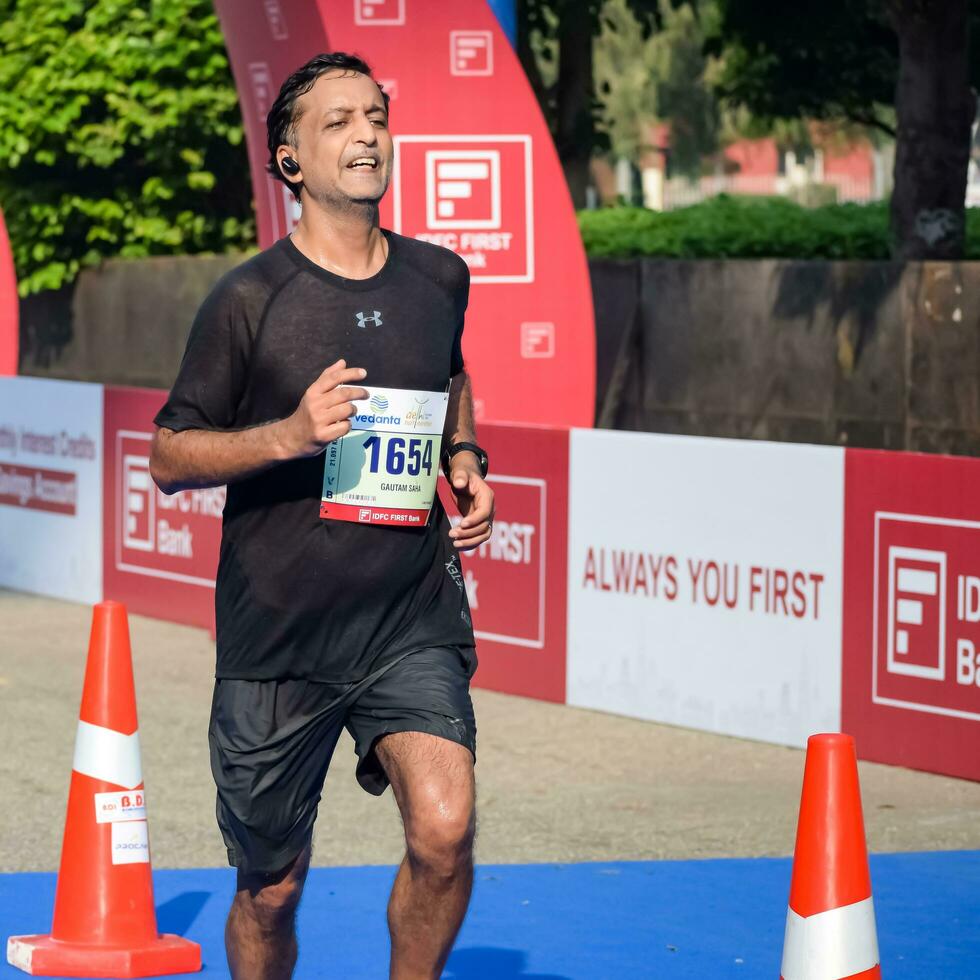 New Delhi, India - July 16 2023 - Vedanta Delhi Half Marathon race after covid in which marathon participants about to cross the finish line, Delhi Half Marathon 2022 photo