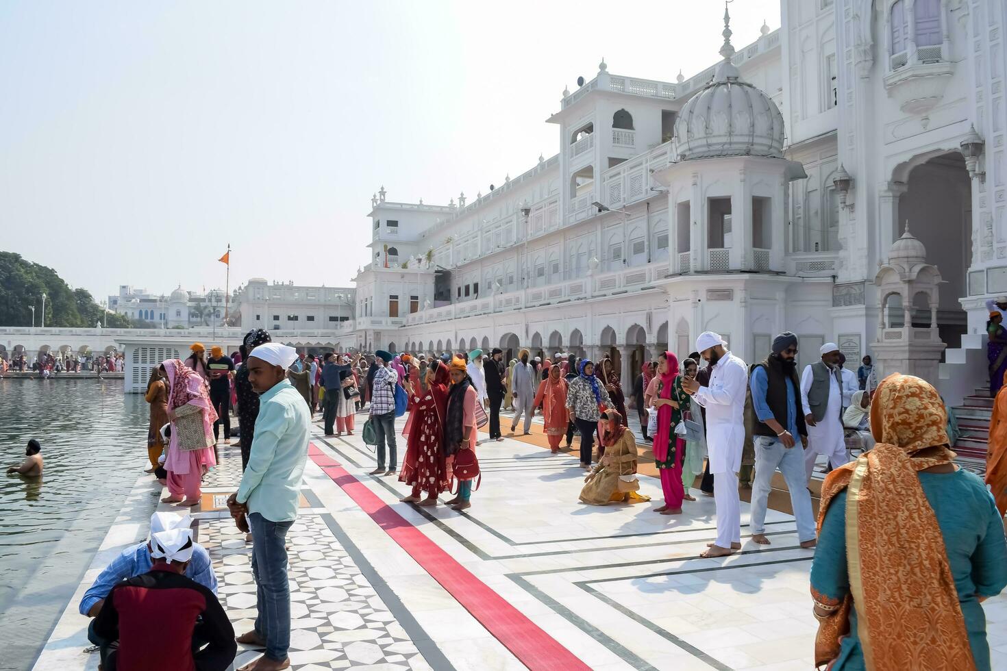 Amritsar, India - February 26 2023 - Unidentified devotees from various parts at Golden Temple Harmandir Sahib in Amritsar, Punjab, India, Famous indian sikh landmark, Golden Temple photo