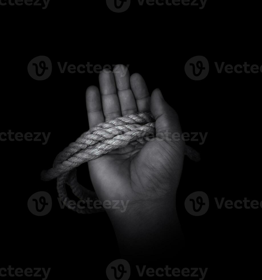 Man's hand holding on to the rope. Hand holding a rope photo