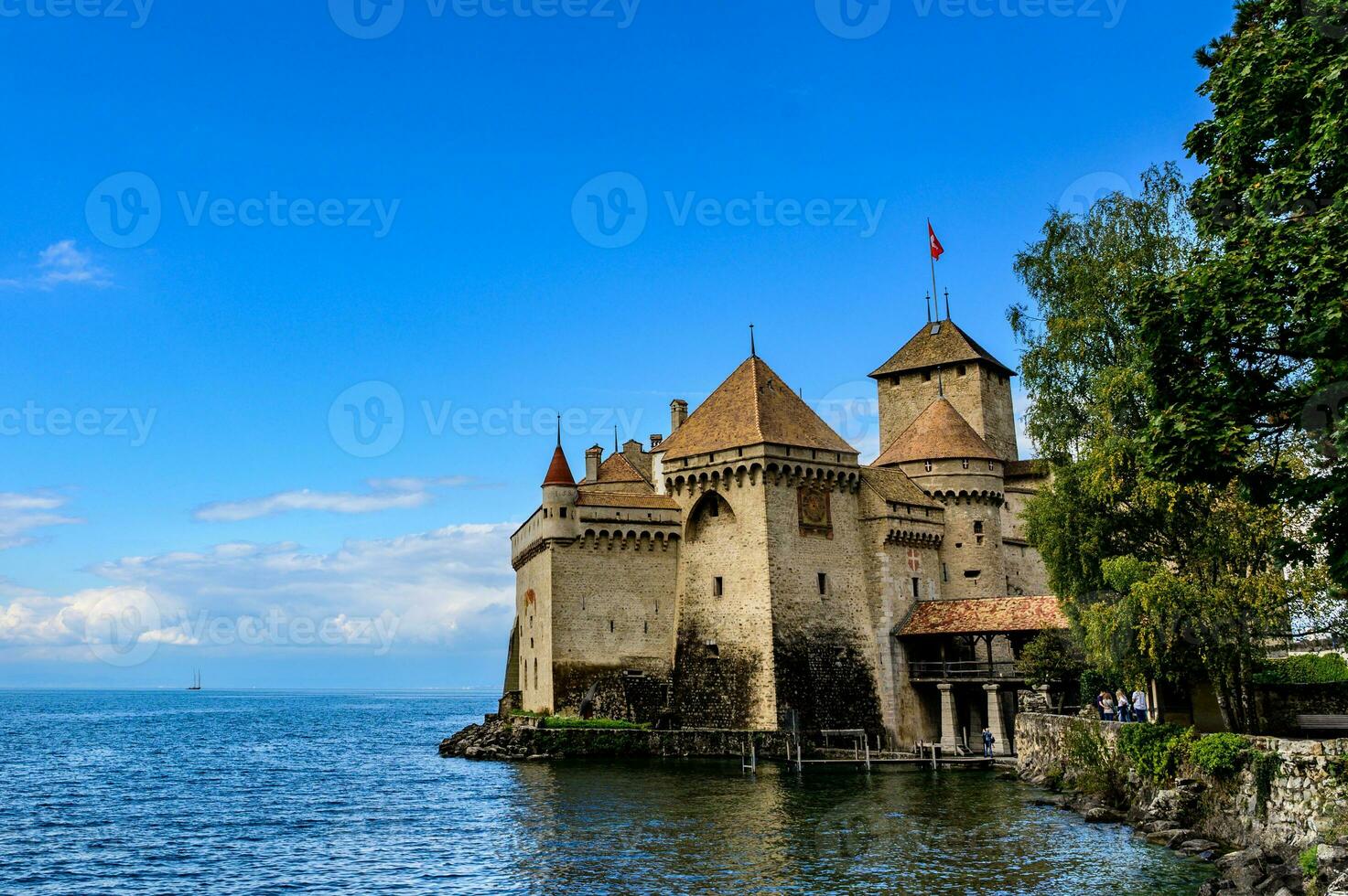 Beautiful old gothic style castle by the lake in blue sky. One of the classic castles is the Chateau De Chillo of Montruex built around the thirteenth century along Lake Geneva, Switzerland, photo