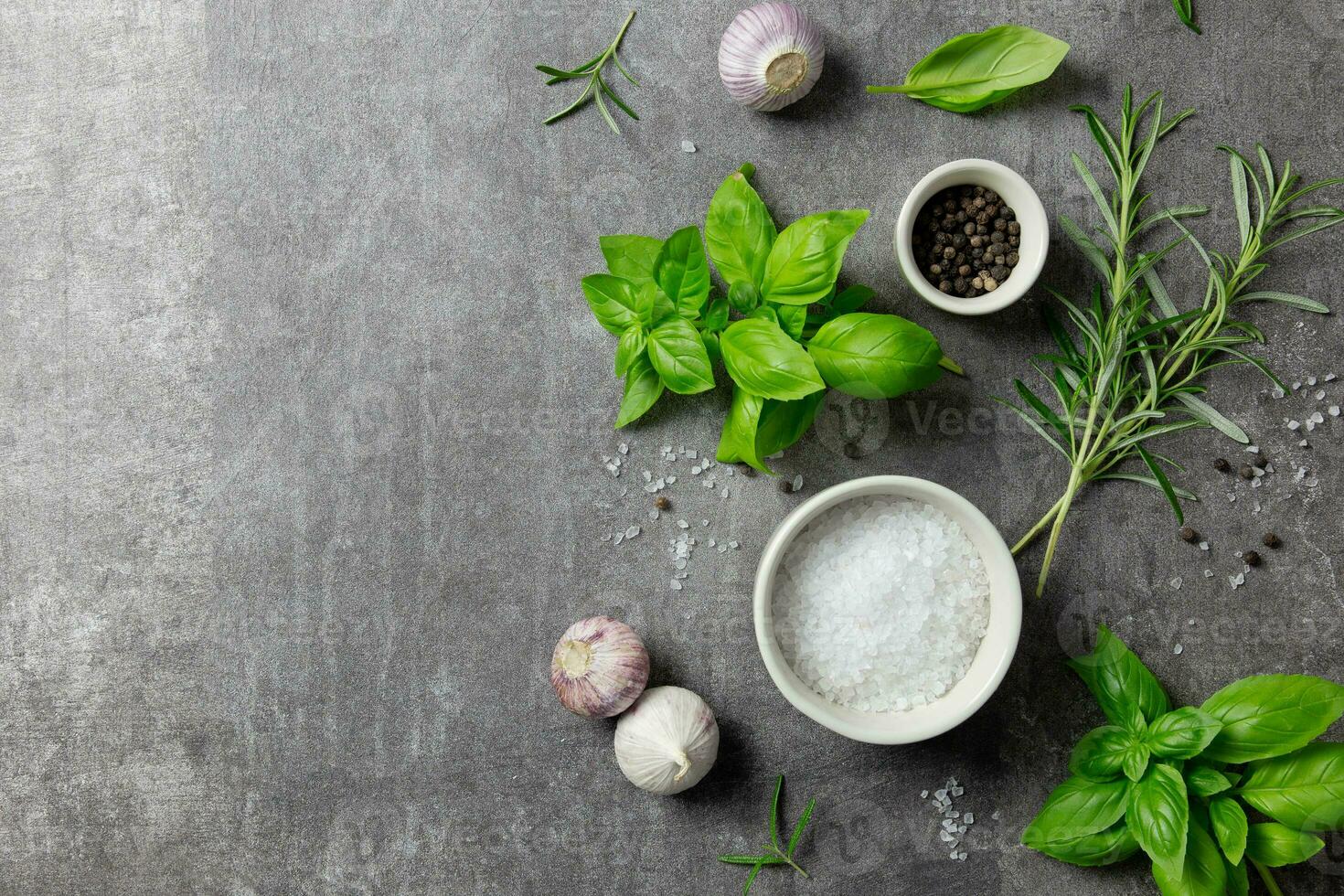 Selection of spices herbs and greens. Ingredients for cooking, food background on dark gray background. Top view. Copy space. photo