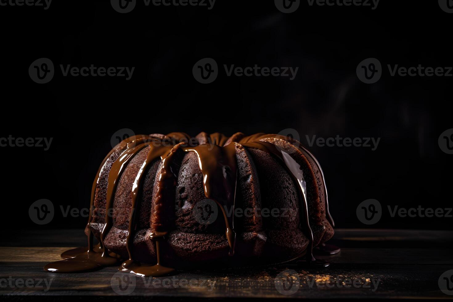 Delicious chocolate bundt cake topped dessert with ganache glaze on dark background with copy space. . photo