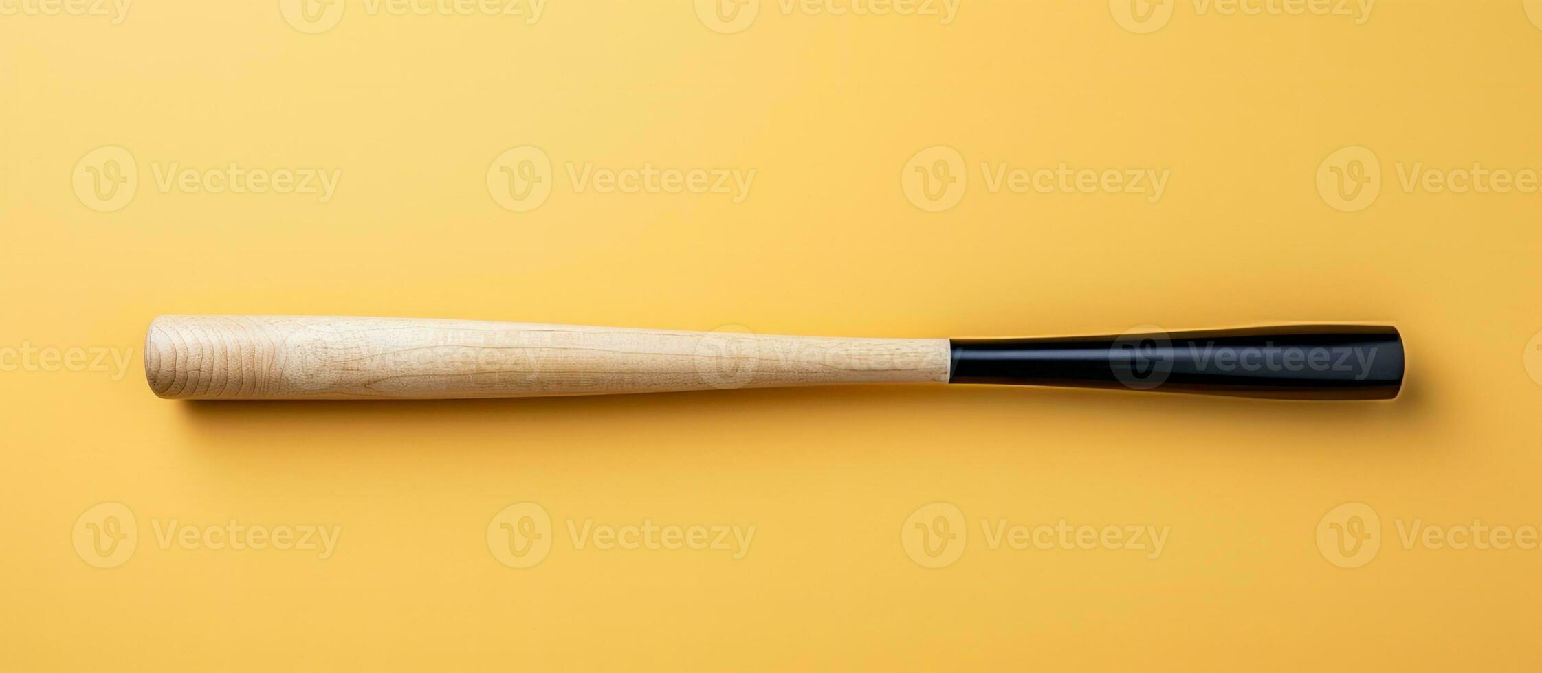 Photo of a black and white baseball bat on a vibrant yellow background with copy space