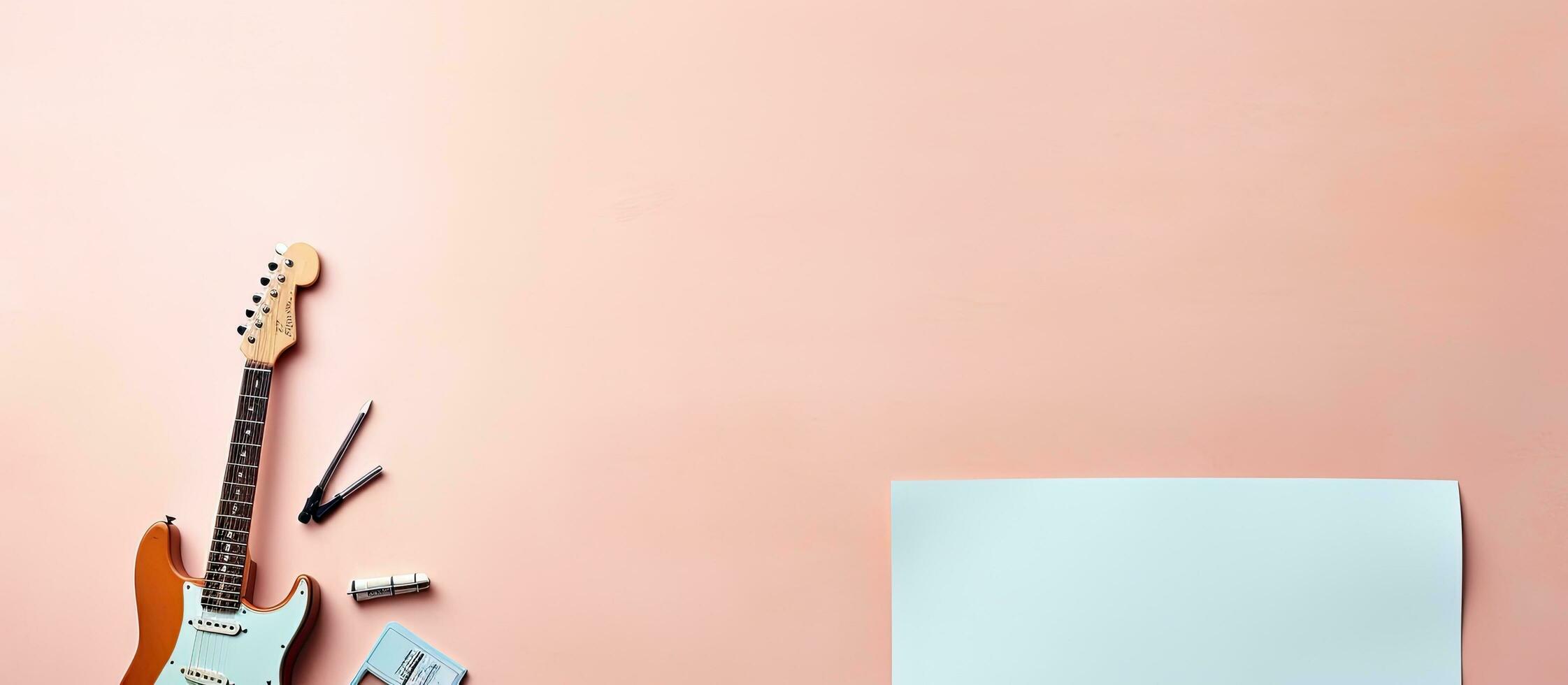 Photo of a guitar, notepad, and scissors on a pink background with copy space with copy space