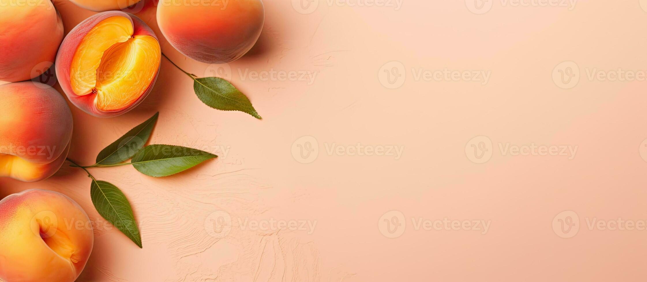 Photo of a vibrant group of peaches with leaves on a lovely pink background with copy space