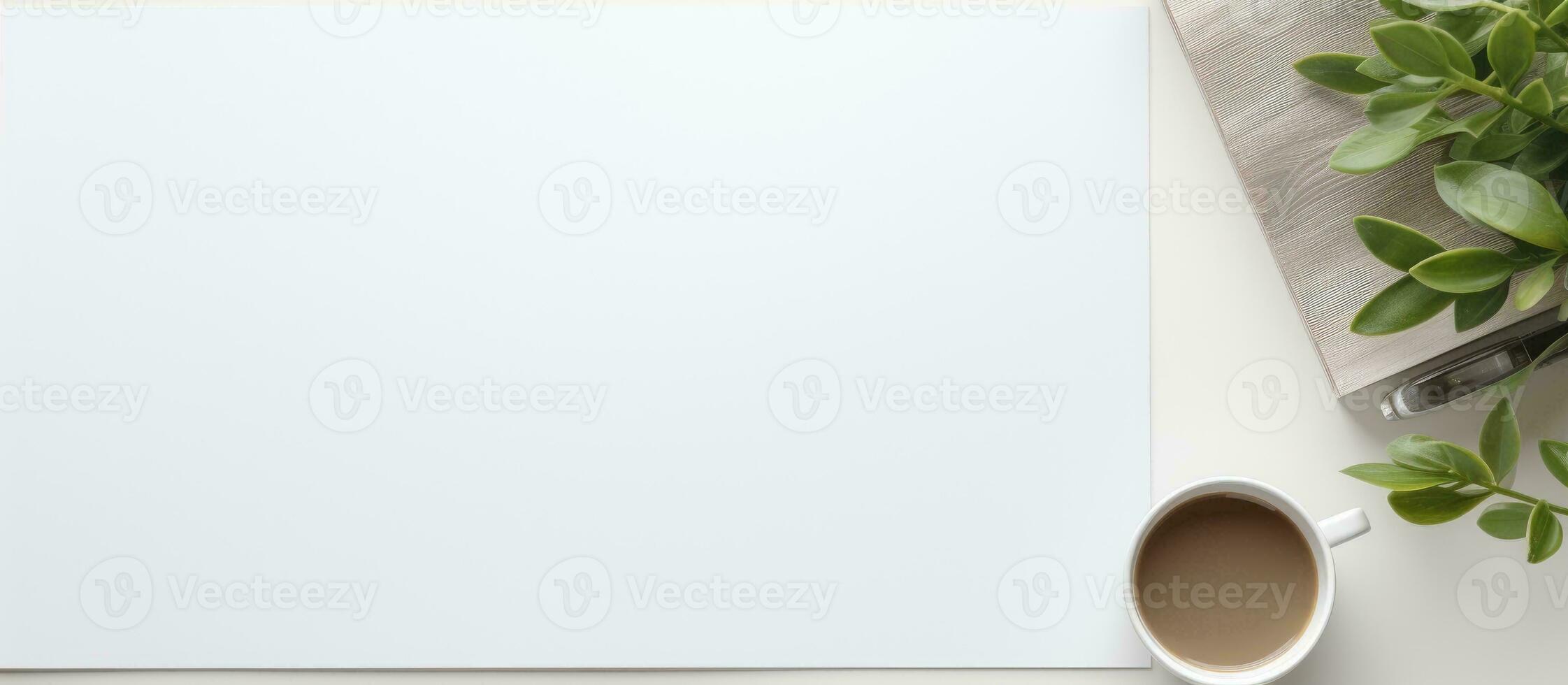 Photo of a blank paper next to a cup of coffee and a plant, perfect for writing or sketching ideas with copy space