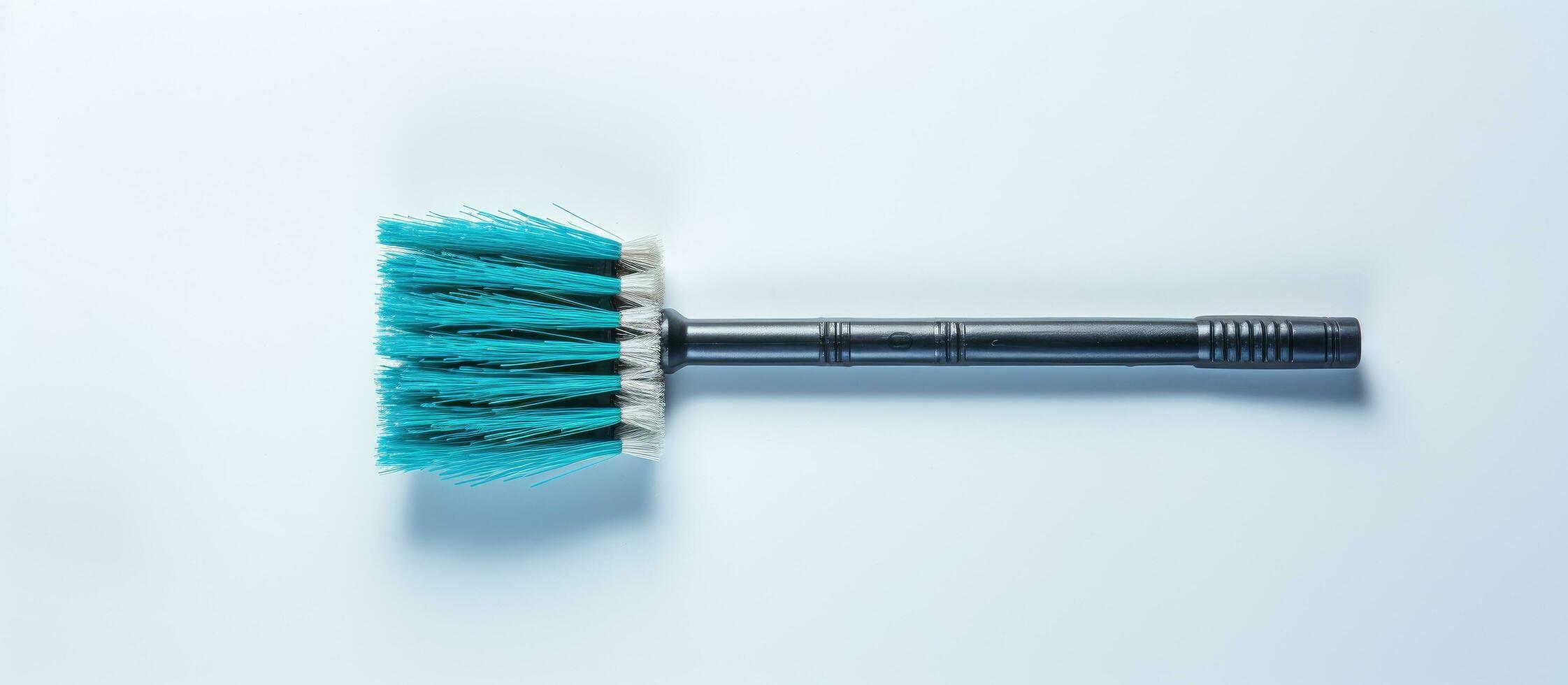 Photo of a blue brush on a clean white surface with copy space