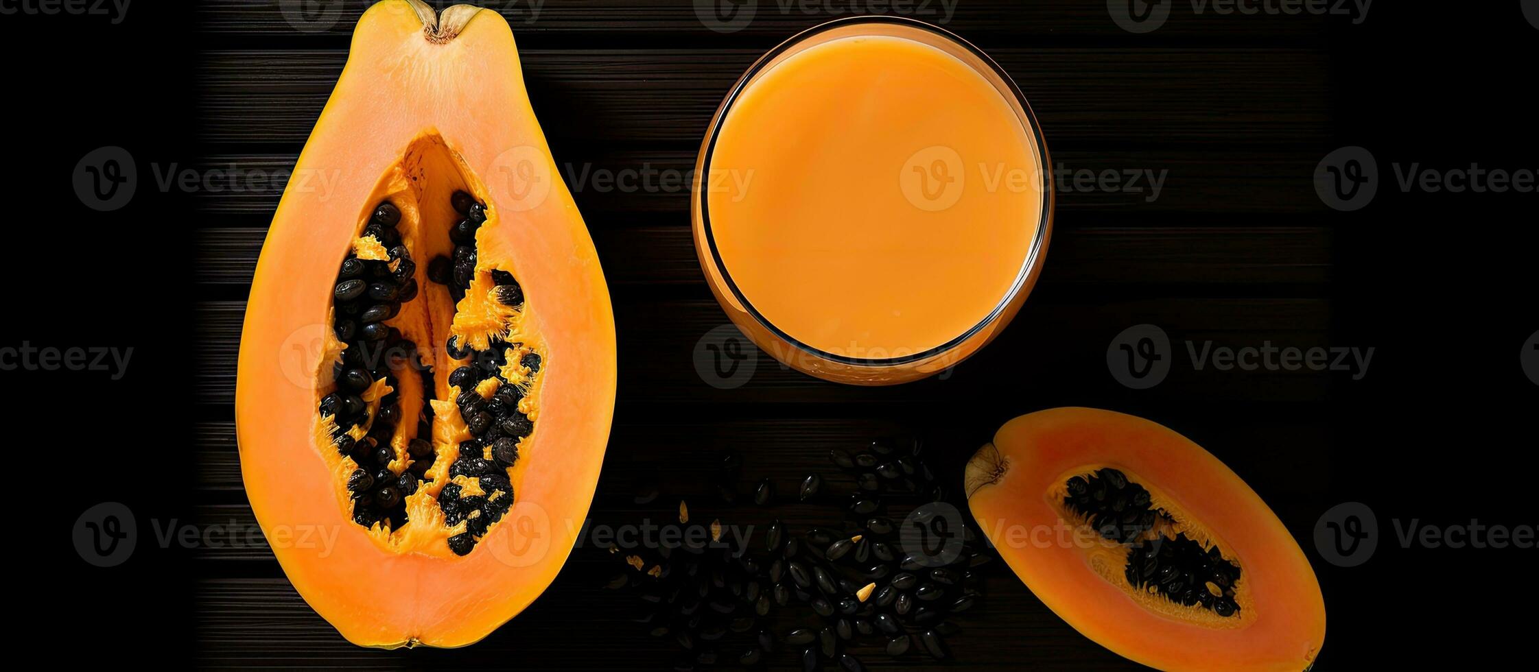 Photo of a halved papaya next to a refreshing glass of orange juice with copy space