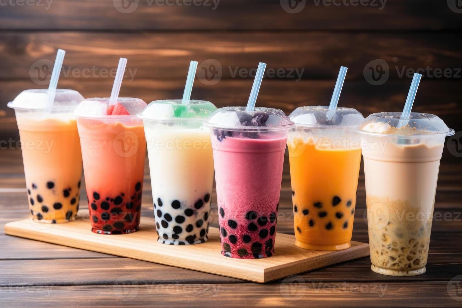 Plastic cups of different tasty bubble tea. Row of fresh boba bubble tea glasses. photo