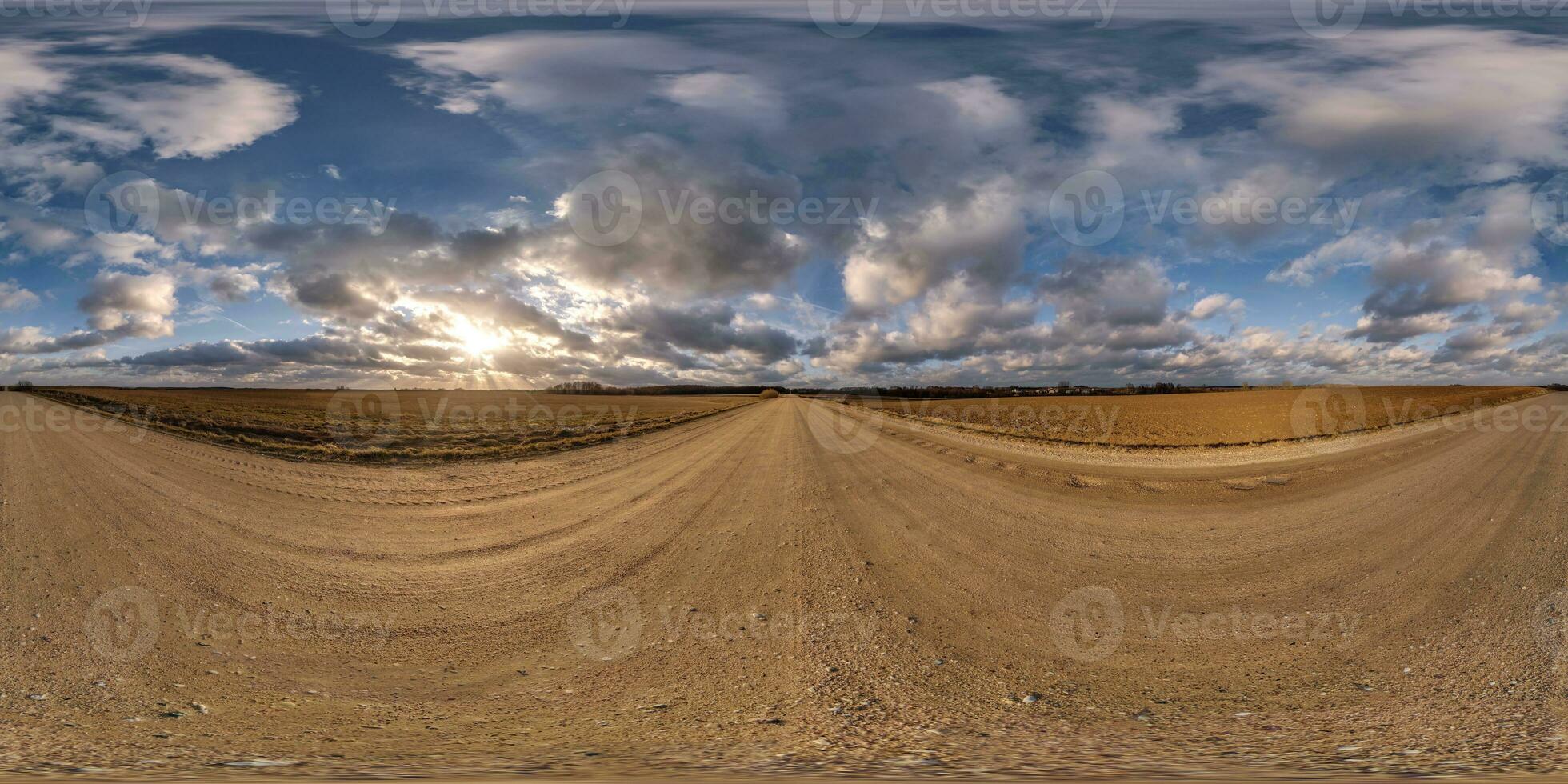 360 hdri panorama on gravel road with evening clouds on blue sky before sunset in equirectangular spherical seamless projection, use as sky replacement in drone panoramas, game development as sky dome photo
