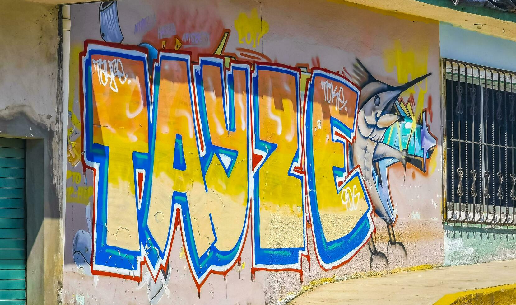 Puerto Escondido Oaxaca Mexico 2023 Wall with graffiti art drawings paintings fish Puerto Escondido Mexico. photo