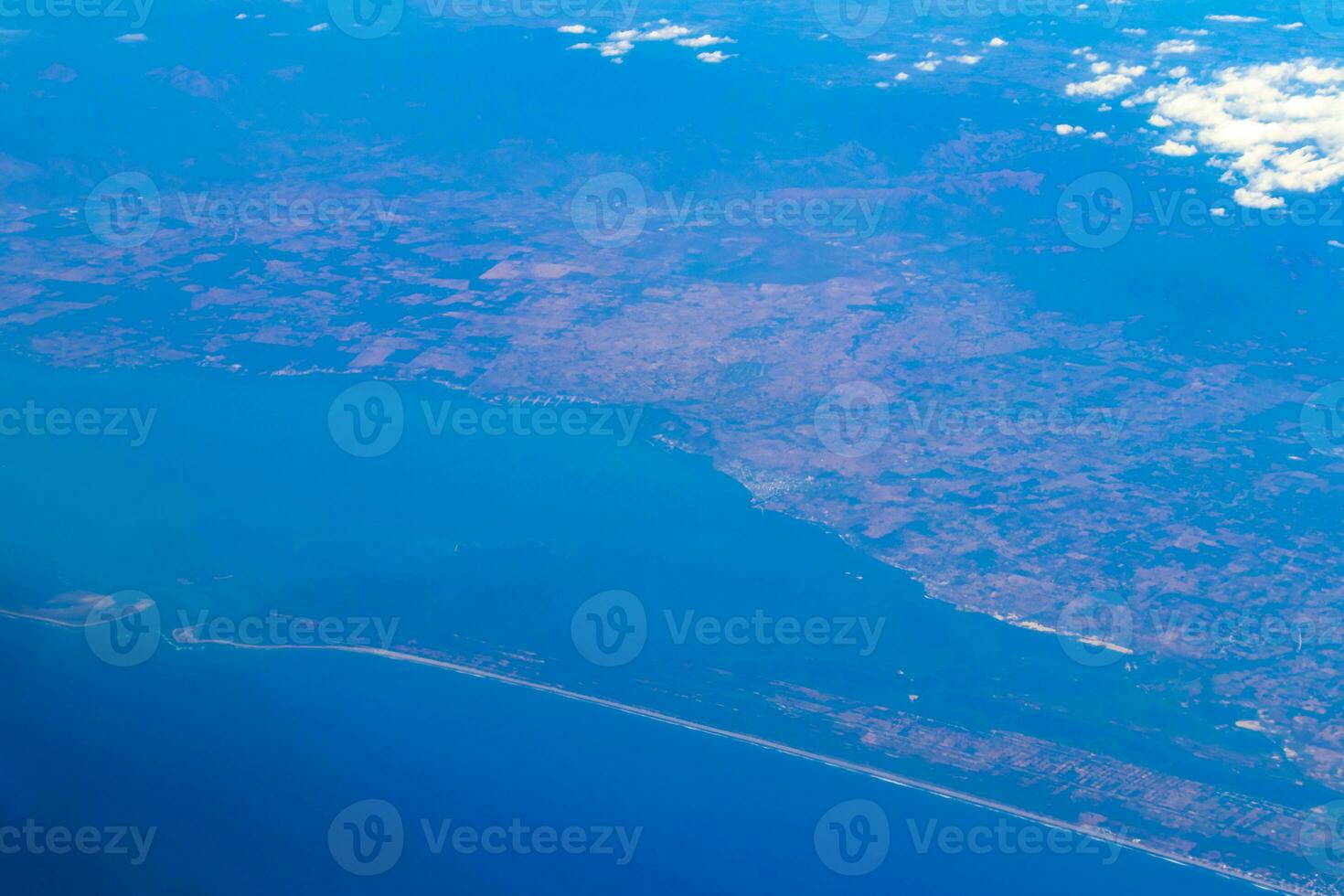 Flying by plane over Mexico view of volcanoes mountains clouds. photo