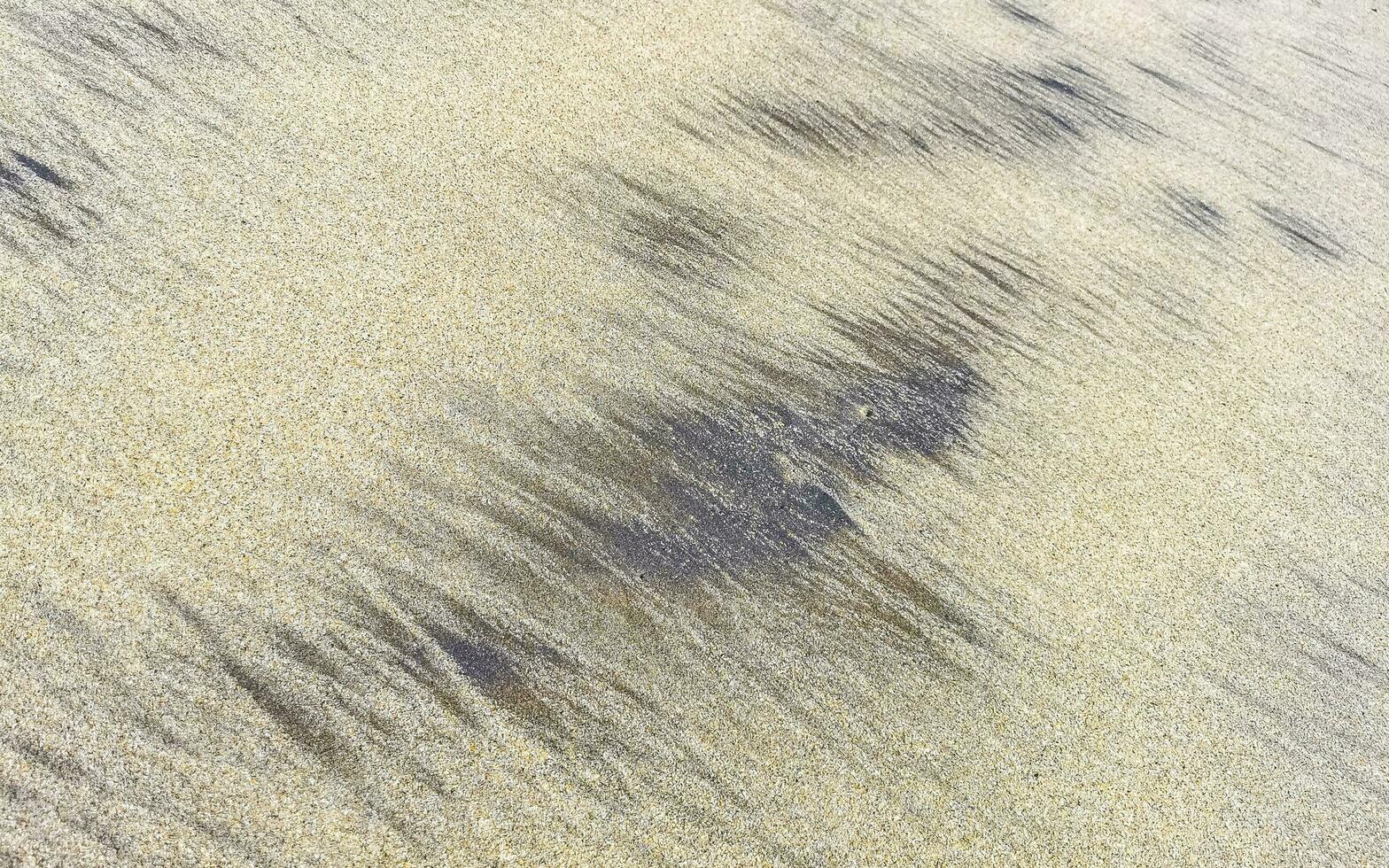 Wet beach sand water and waves texture and pattern in Mexico. photo