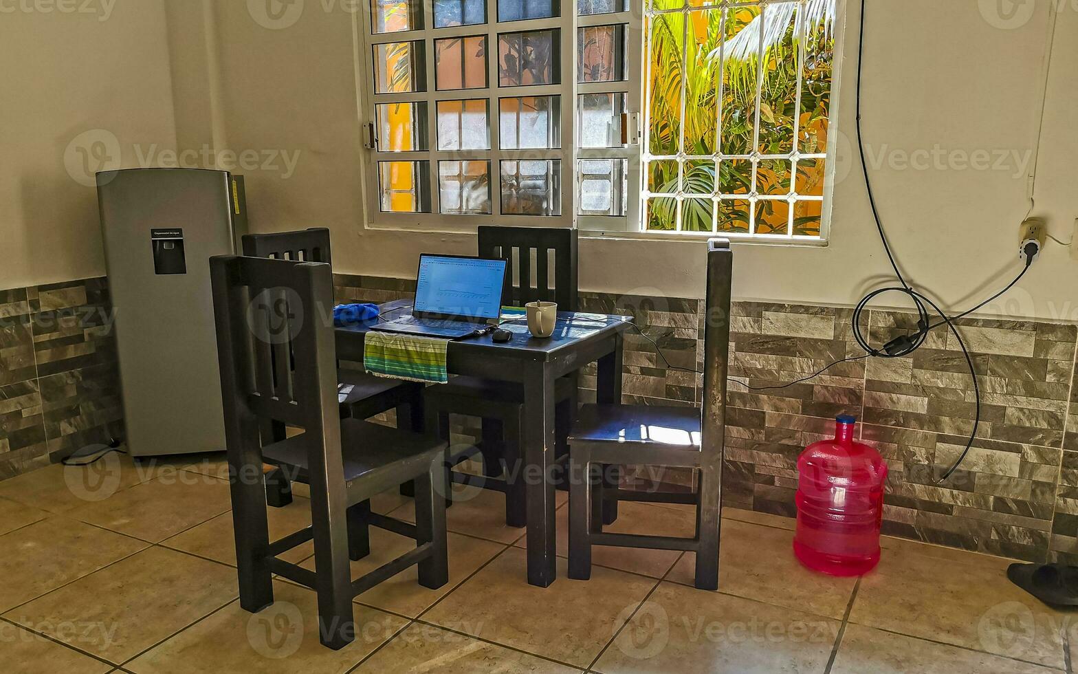 Simple small apartment hotel room with bed table in Mexico. photo