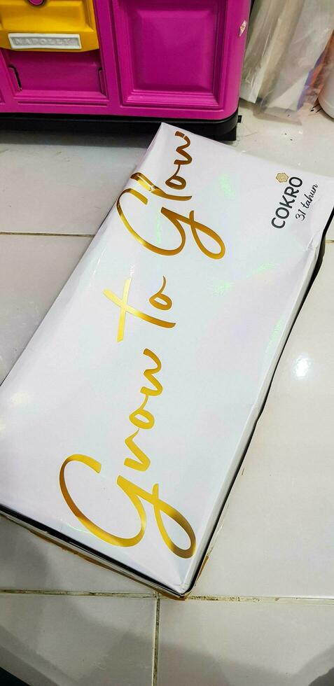 Bekasi, Indonesia in May 2018. A Bluder Cokro box, with Grow to Glow written on it. Bluder Cokro is a typical Madiun cake or cake photo