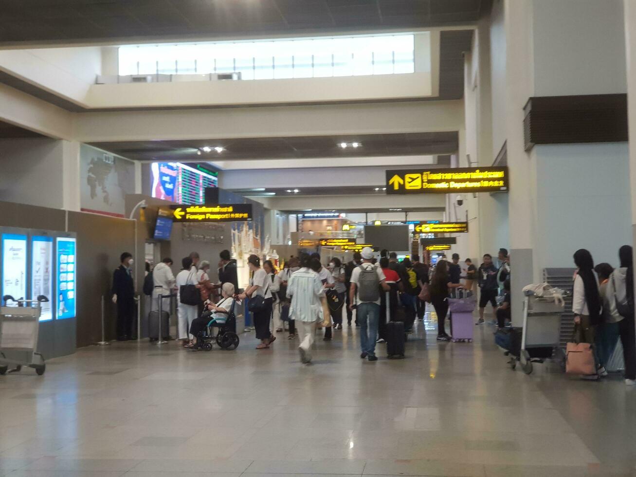 Bangkok, Thailand on July 9, 2023. Several people are lining up to check foreign passports to enter immigration counter. photo