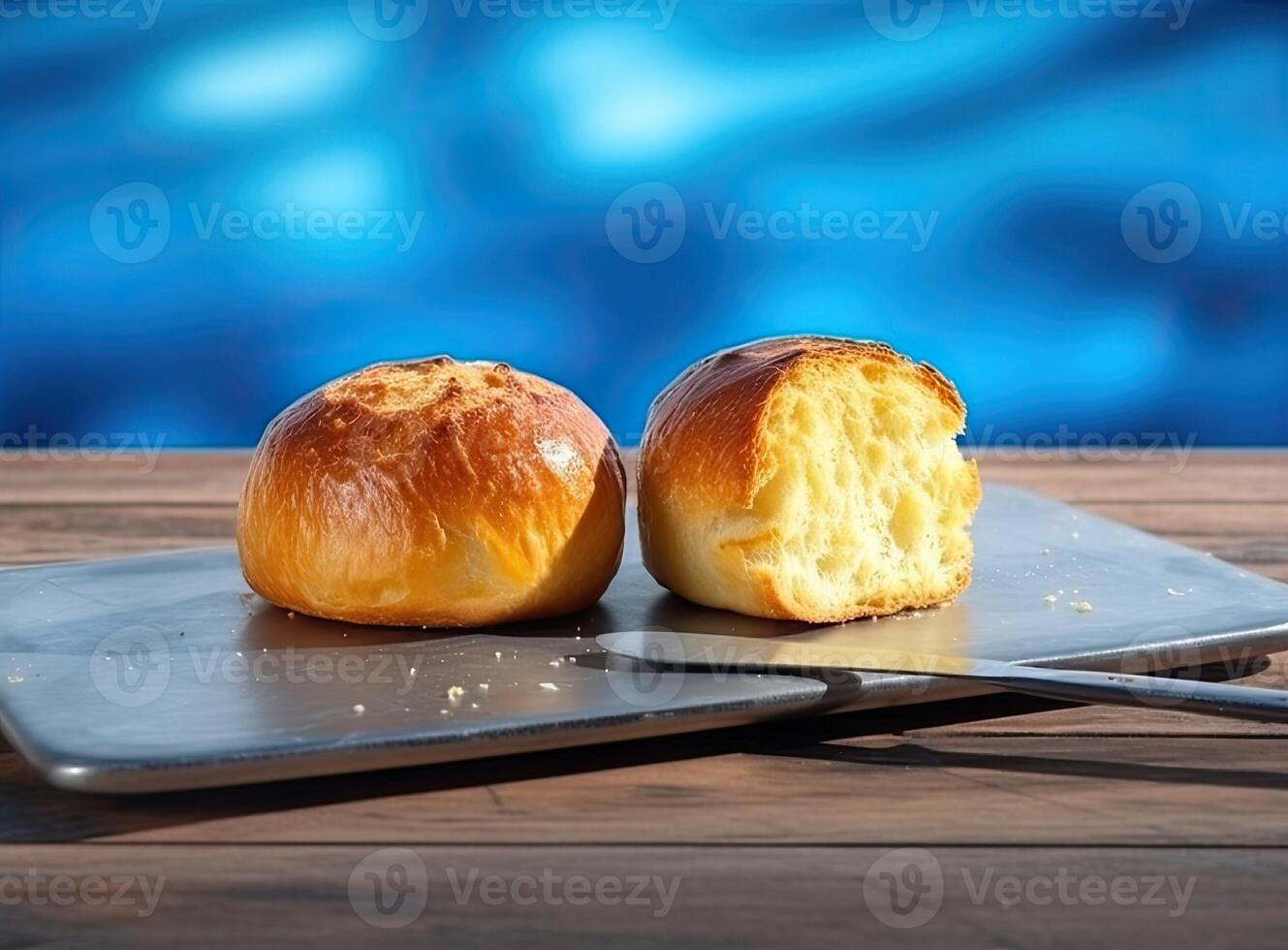 Foil wrapped processed cream cheese, table knife and slice of bread on a cutting board over blue wooden table. Small triangular pieces of soft cheese. Created with Generative AI technology. photo