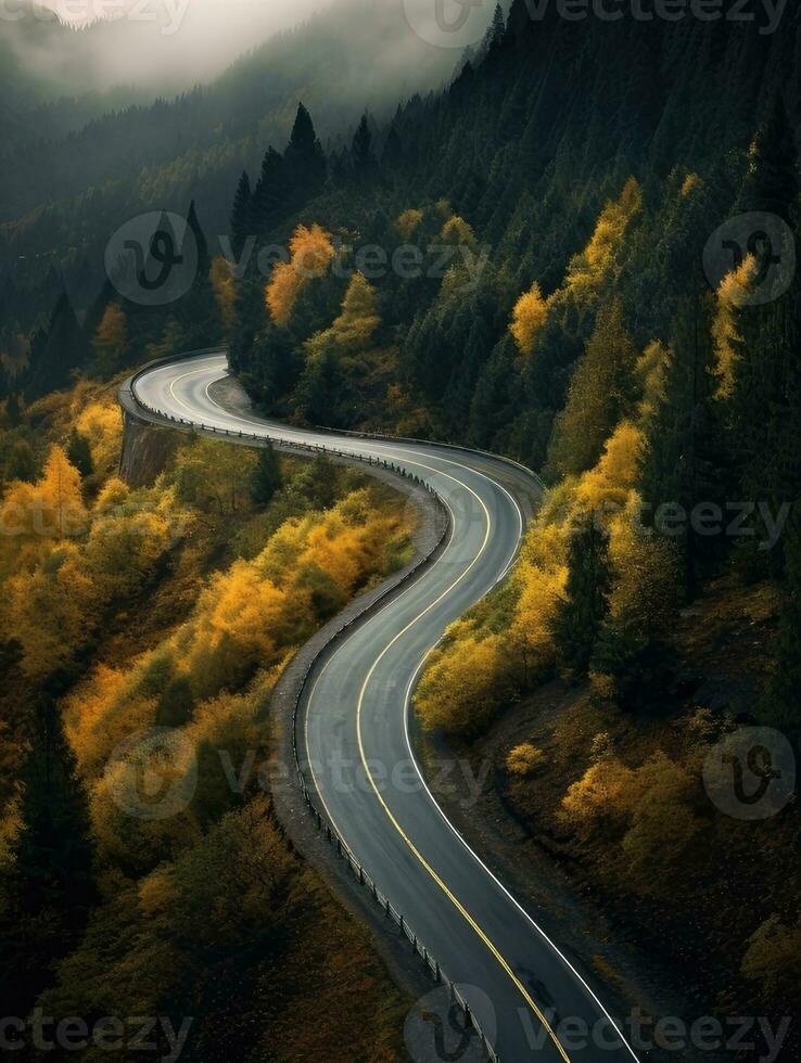 Dark misty day with empty Winding mountain road. Created with Generative AI technology. photo