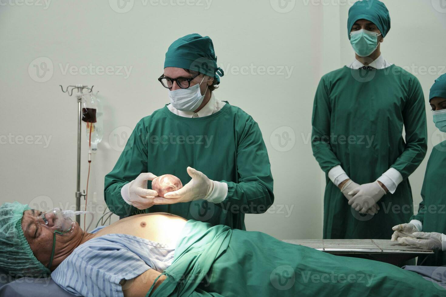 Practitioner doctors give the heart to specialist surgeons for change, medical technology, professional surgery operations on critically ill patients in hospital's ICU, and paramedic occupation. photo