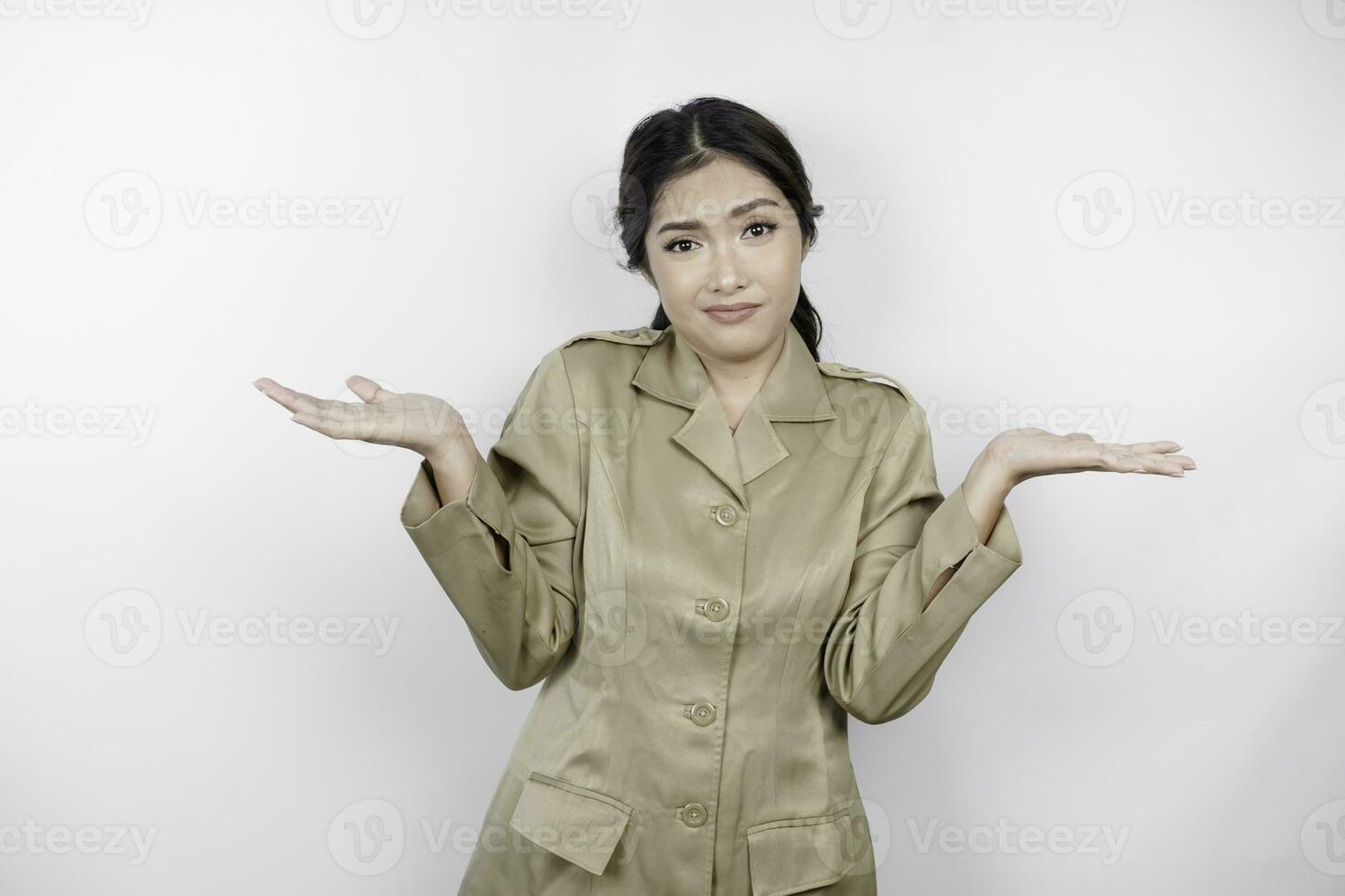 Confused Asian government worker woman have thinking gestures. PNS wearing a khaki uniform. photo