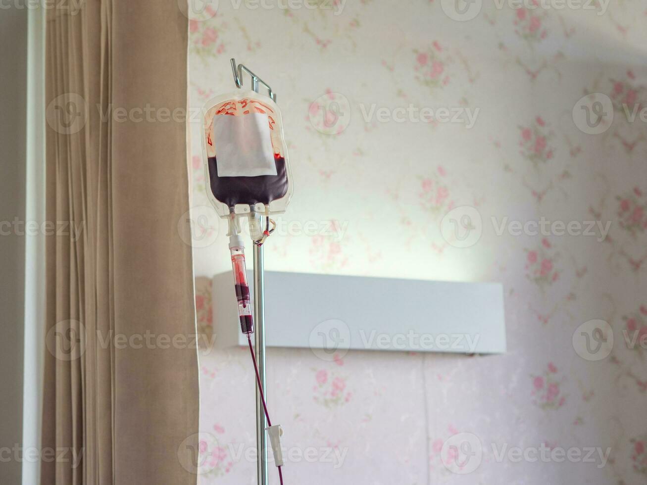 Blood bag for patient to treat anemia hanging in the patient room in the hospital photo