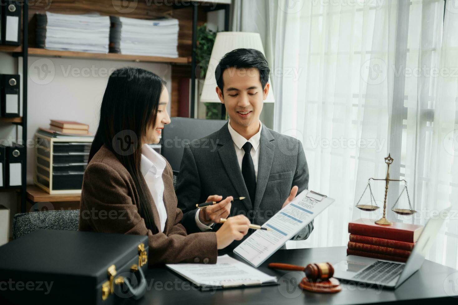 Business Asian people and lawyers discussing contract papers sitting at the table. Concepts of law, advice, legal services. photo