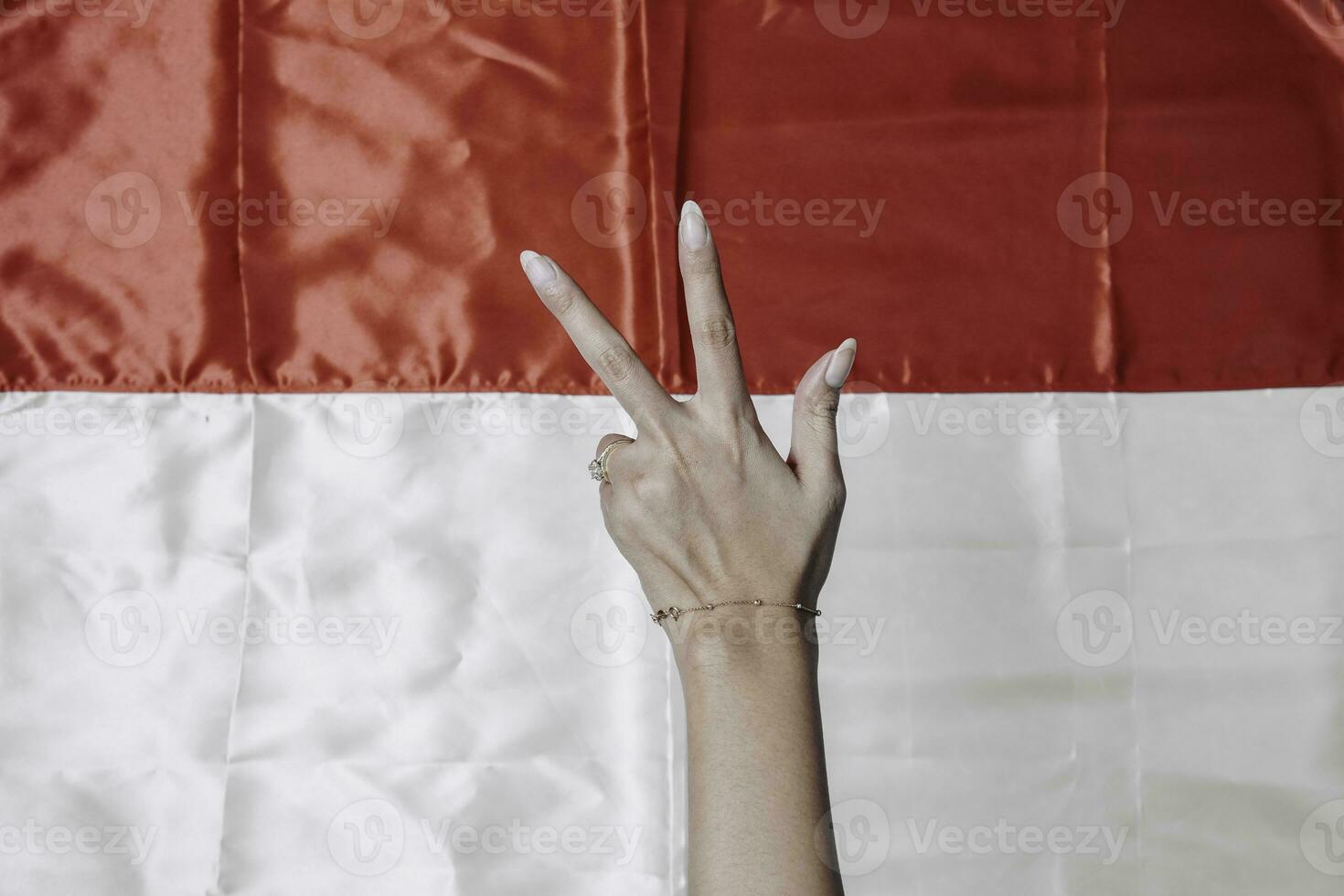 Hands gesturing signs of number isolated by Indonesian red and white flag. Indonesia's independence day concept photo