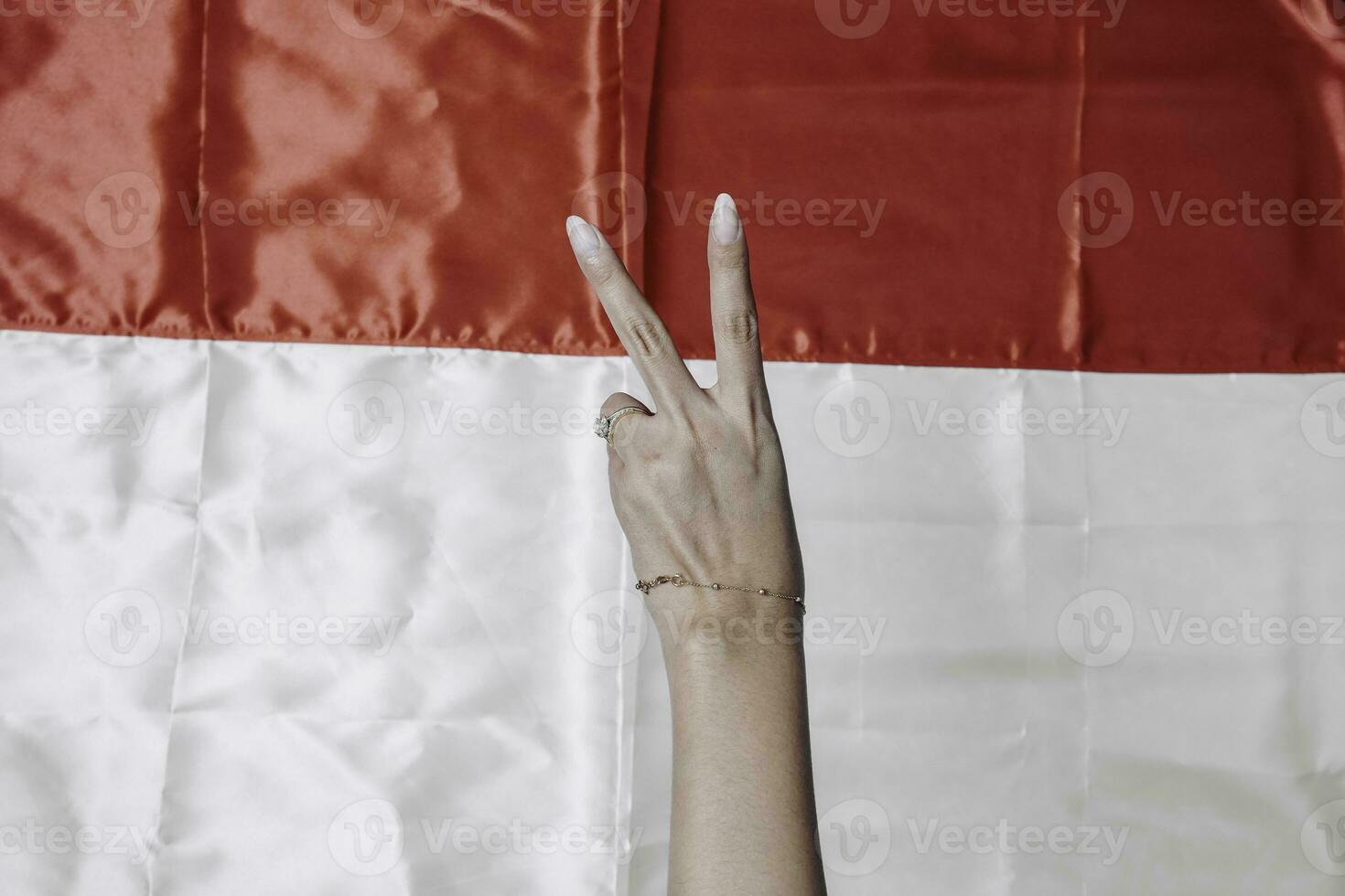 Hands gesturing signs of number isolated by Indonesian red and white flag. Indonesia's independence day concept photo