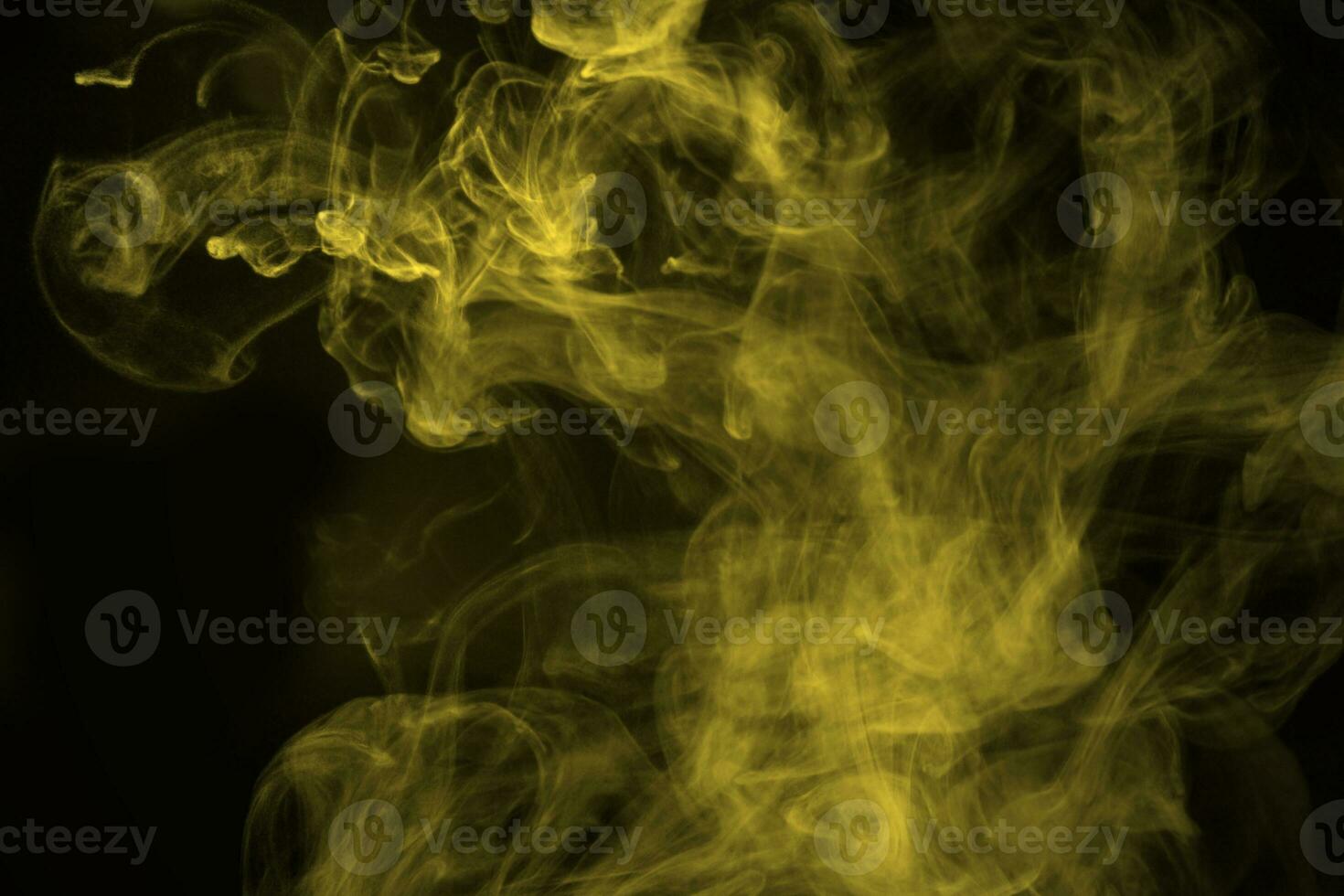 Abstract  golden powder or smoke isolated on black background photo