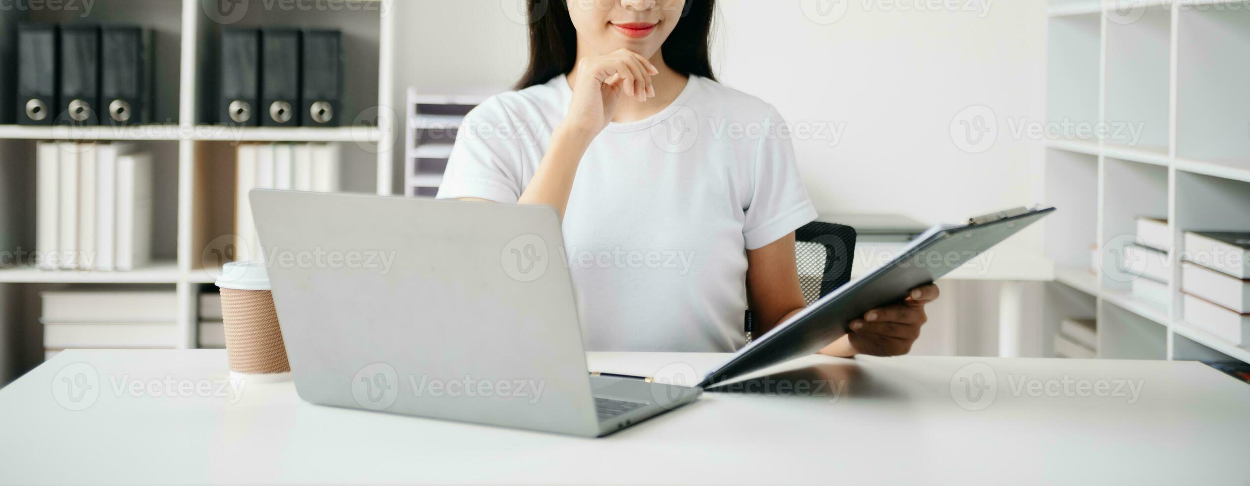 Working Process in Modern Office. Young Woman Account Manager Working at Table with New Business Project. ,Using Contemporary Laptop. photo