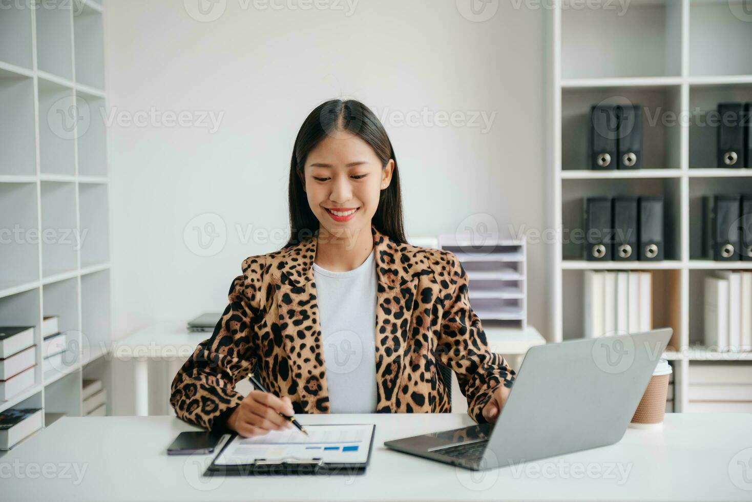Business woman using tablet and laptop for doing math finance on an office desk, tax, report, accounting, statistics, and analytical research concept in office photo