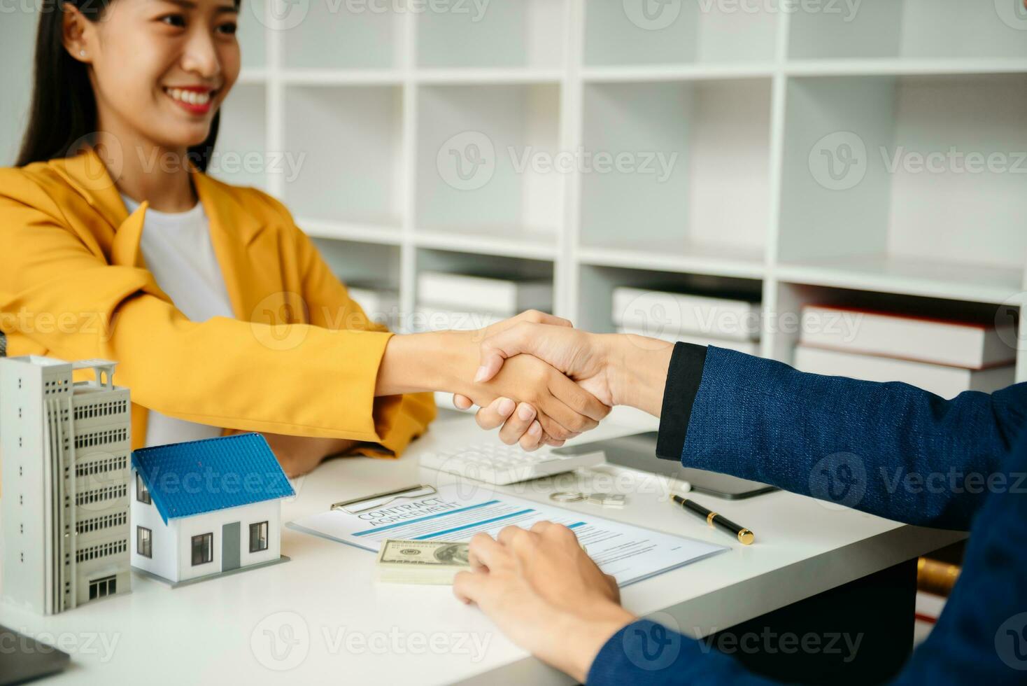 Signing a contract. Client and broker agent, lease agreement, successful deal and  Young business sitting at the desk in office photo
