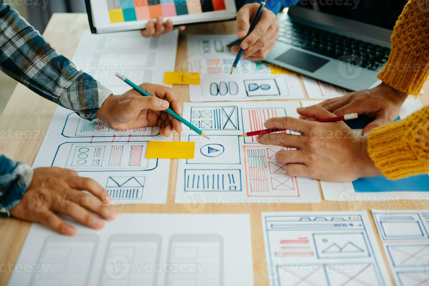 View of UI developer team brainstorming on their project with laptop, smartphone and digital tablet. Creative digital development agency. photo