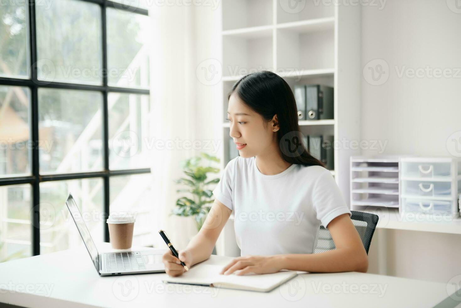 Business woman using tablet and laptop for doing math finance on an office desk, tax, report, accounting, statistics, and analytical research concept in office photo