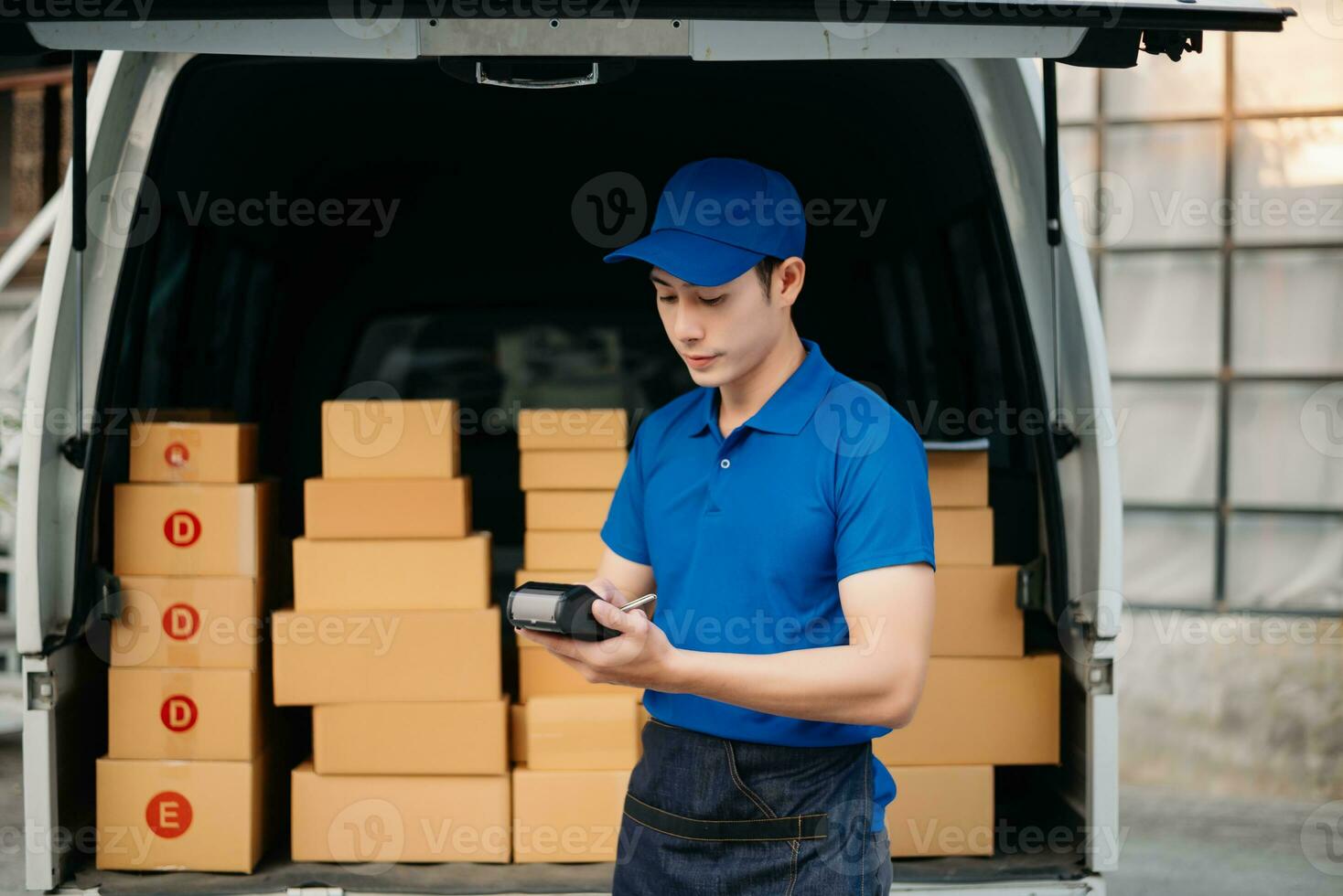Portrait of courier delivery Asian man searching the address on digital tablet. Delivery service, delivery home and shipping concept. photo