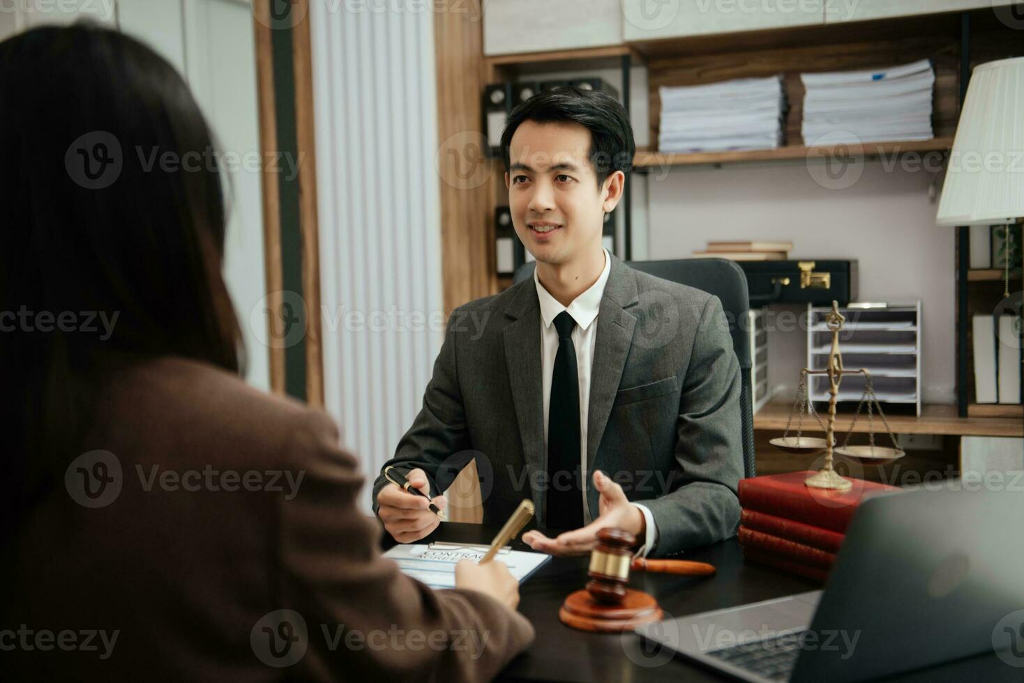 Business law concept, Lawyer business lawyers are consulting lawyers for women entrepreneurs to file copyright lawsuit with laptop and tablet at office photo