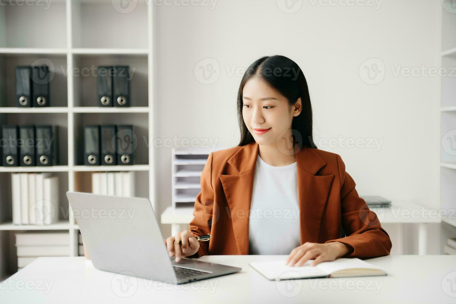 Business woman using tablet and laptop for doing math finance on an office desk, tax, report, accounting, statistics, and analytical research concept in office photo