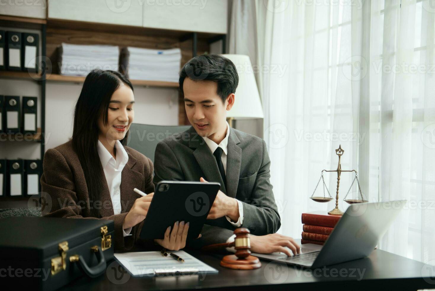 Business Asian people and lawyers discussing contract papers sitting at the table. Concepts of law, advice, legal services. photo