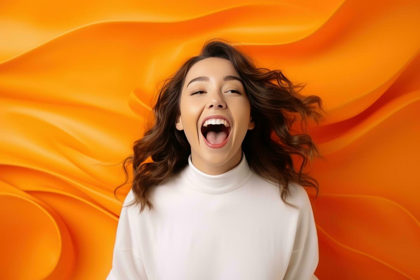 Happy woman standing on orange background shocked photo