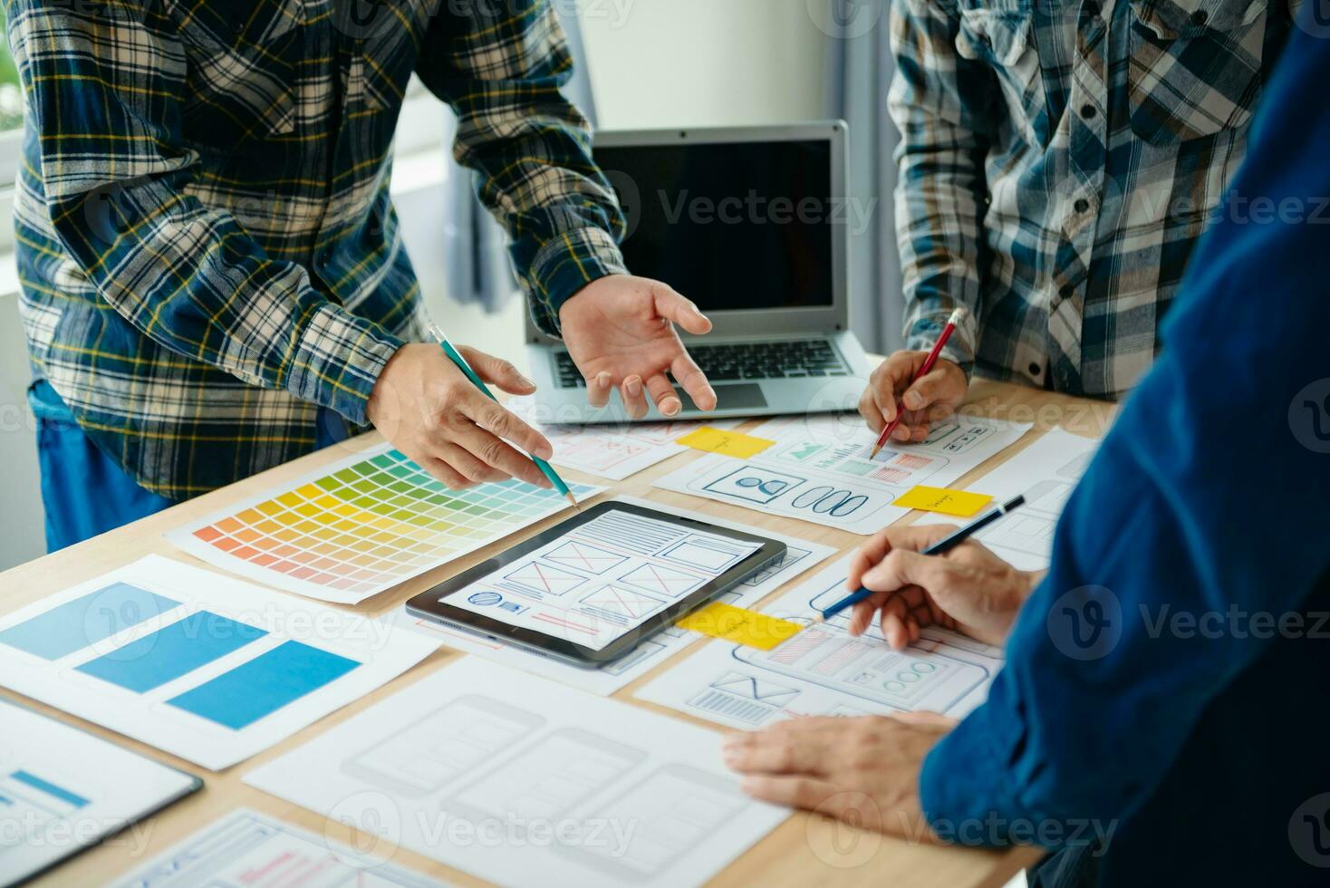 UX developer and ui designer brainstorming about mobile app interface wireframe design with customer breif and color code at modern office. photo