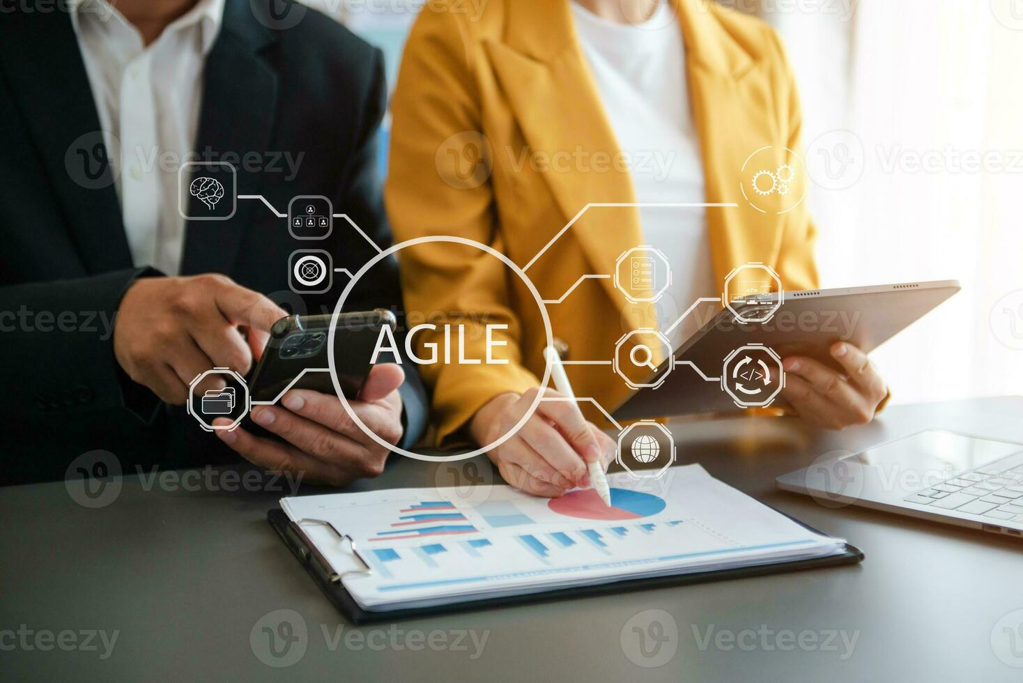 Agile development methodology concept. Business hand using laptop computer and tablet with virtual screen Agile icon on modern office photo