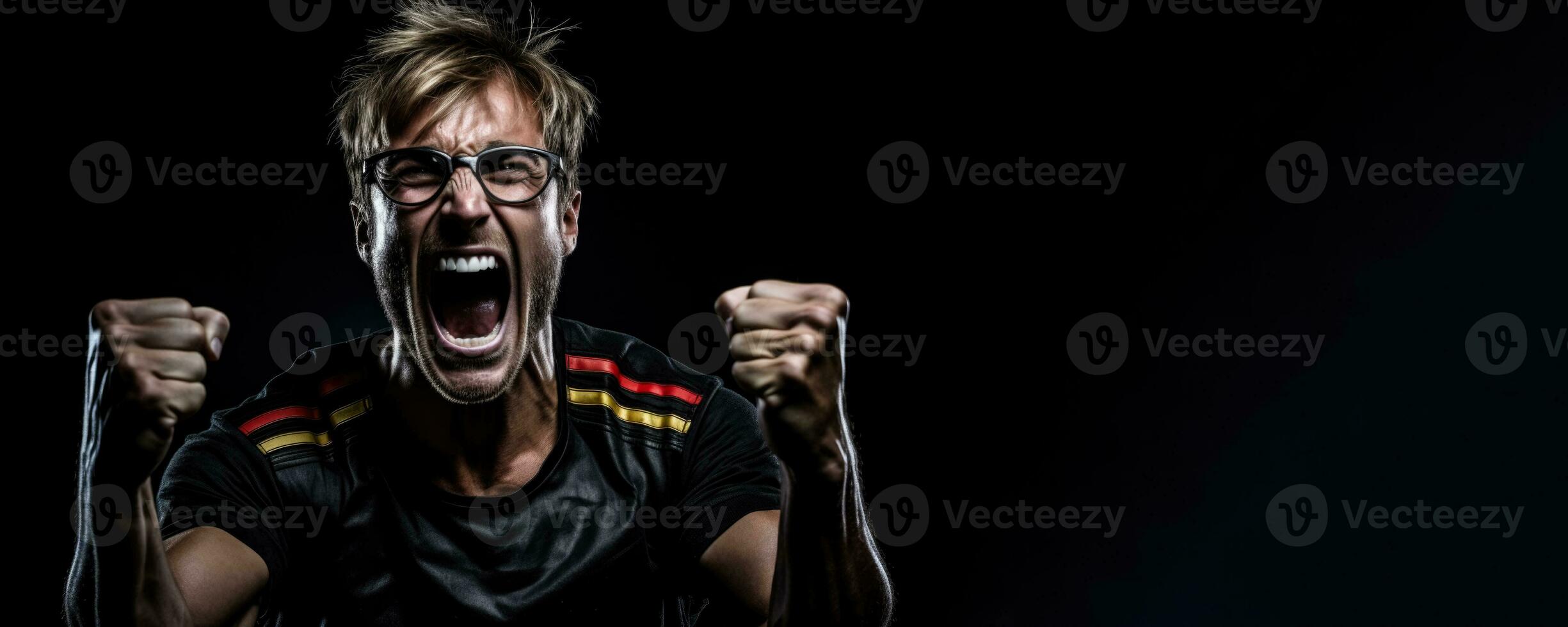 German football fan celebrating a victory on black background with empty space for text photo