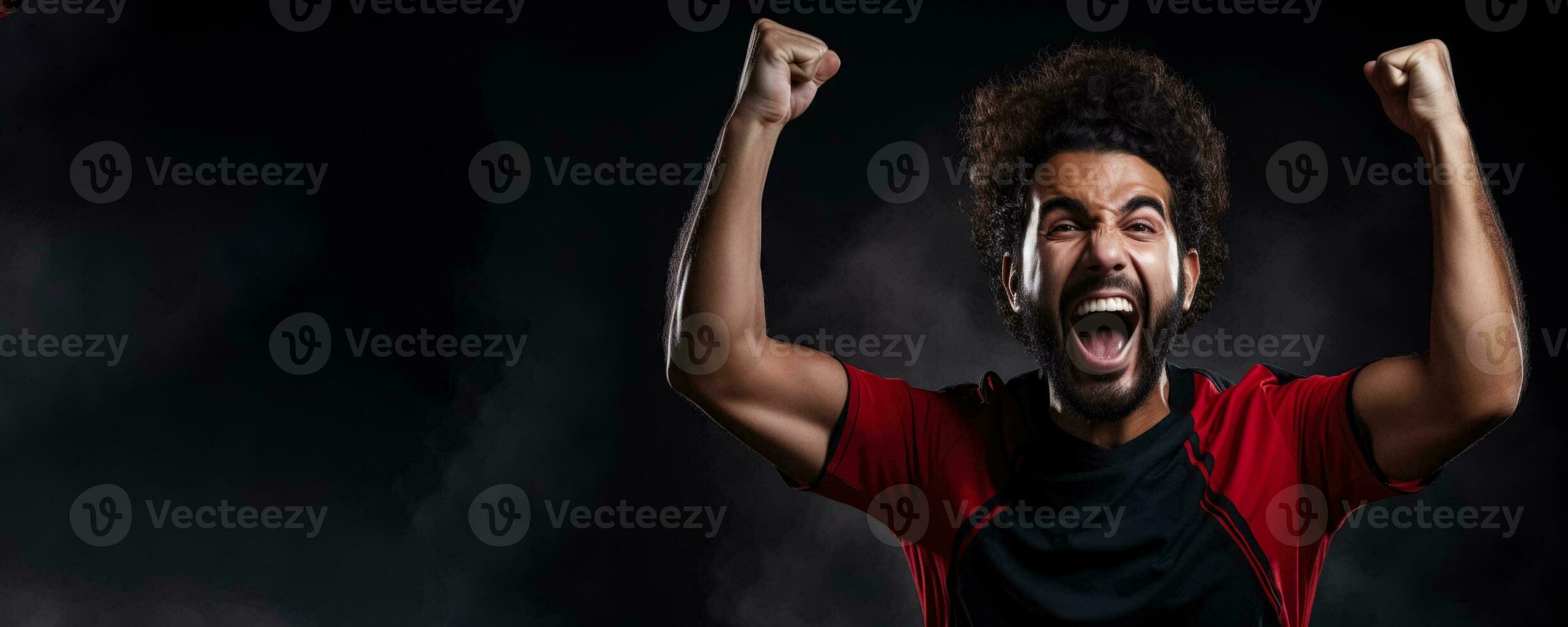 Egyptian football fan celebrating a victory on red white and black background with empty space for text photo