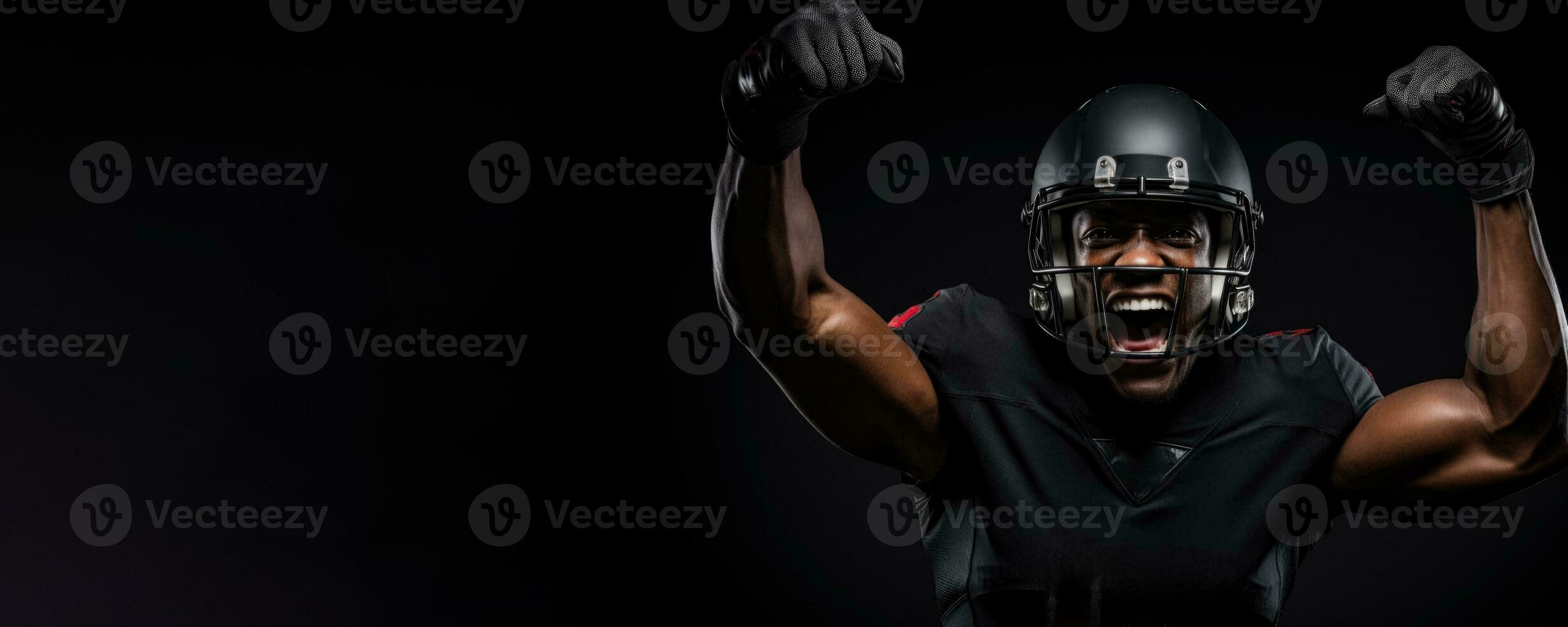 American football player celebrating a game-changing interception on black background with empty space for text photo