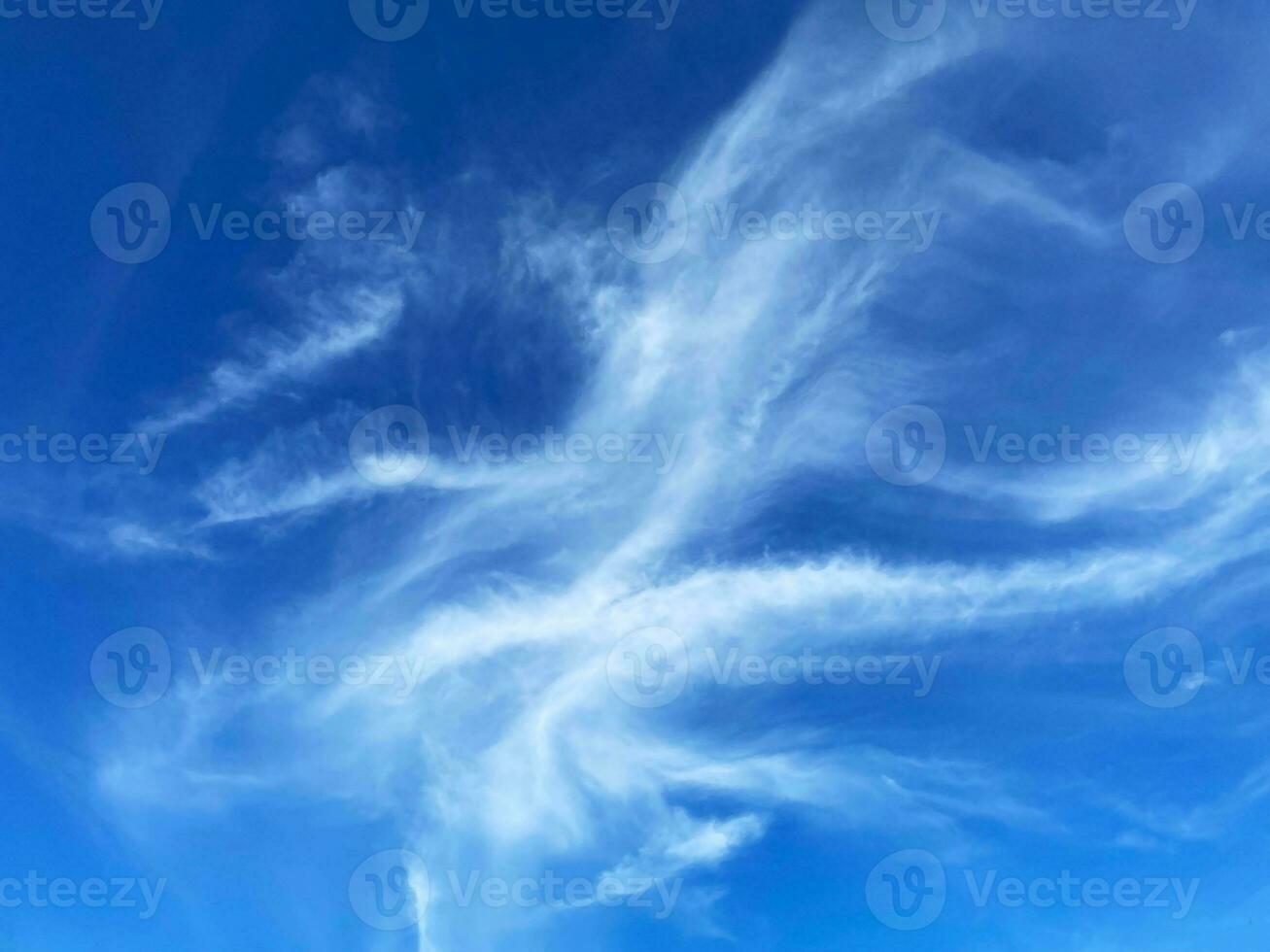 Cirrus clouds on blue sky background photo