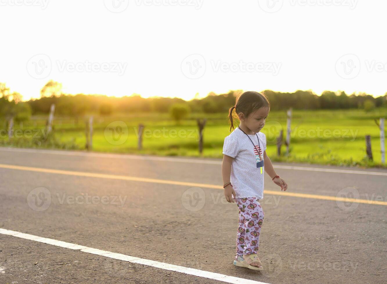 Silhouettes of kid walking forward to rising sun in the mountains at summer, healthy family vacation, dream and happy childhood, endless summertime, beautiful summer landscape, golden tones photo