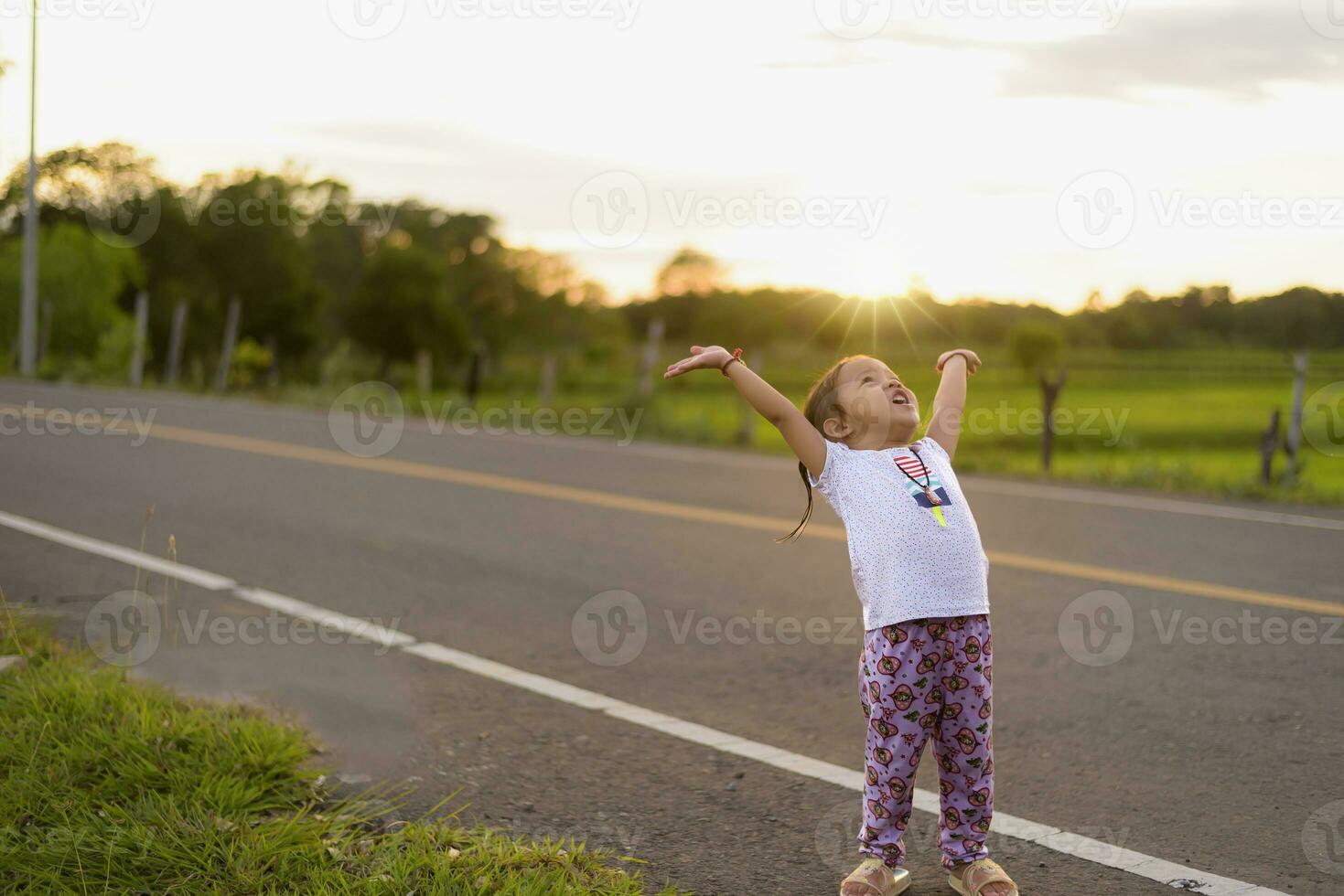 Healthy woman celebrating during beautiful happy sunset. photo