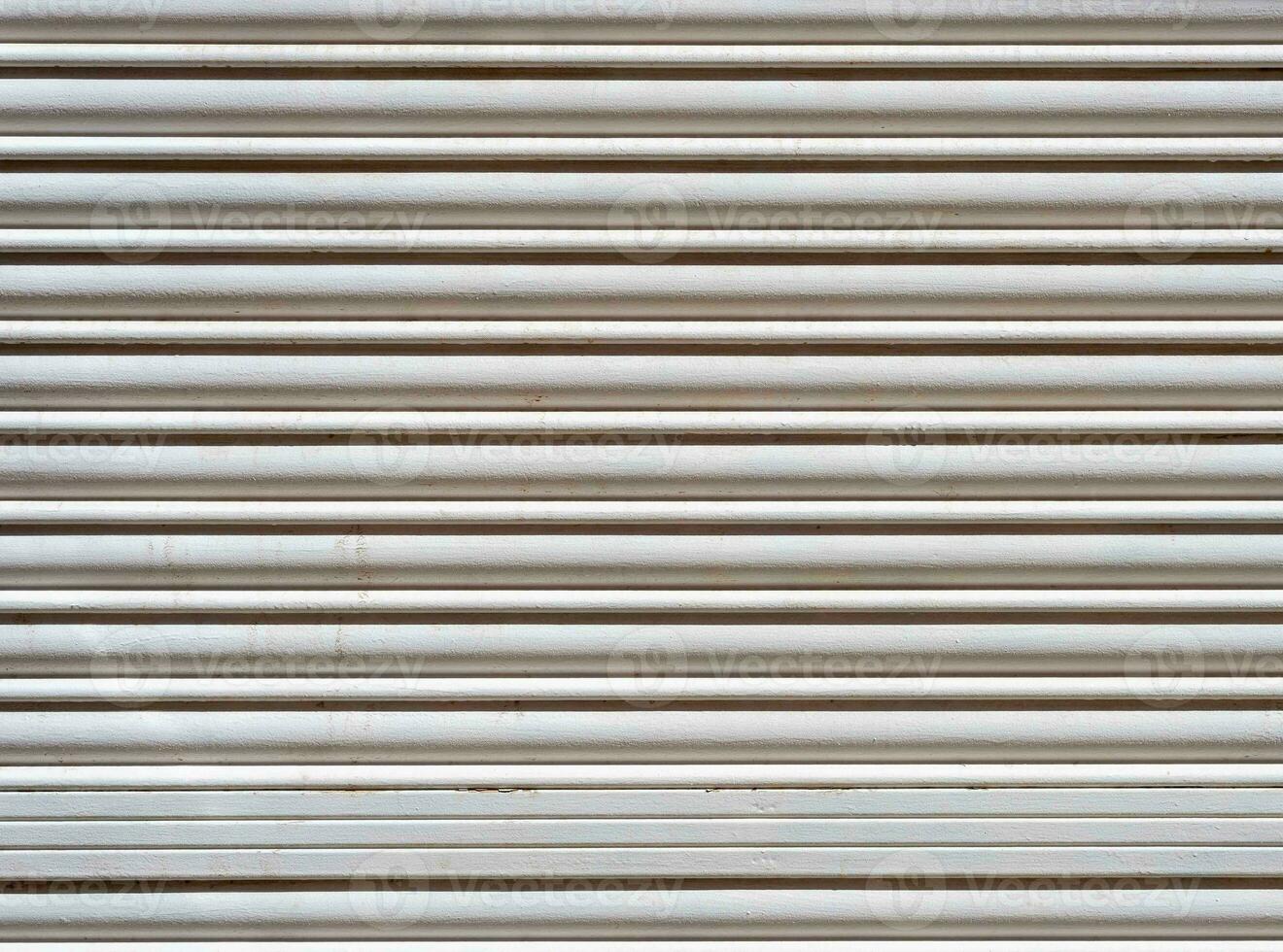 Textured background of white wooden roller shutter door close up photo