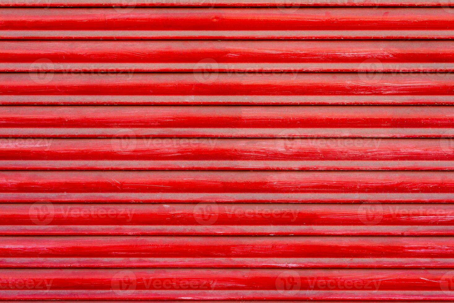 Textured background of red wooden roller shutter door close up photo