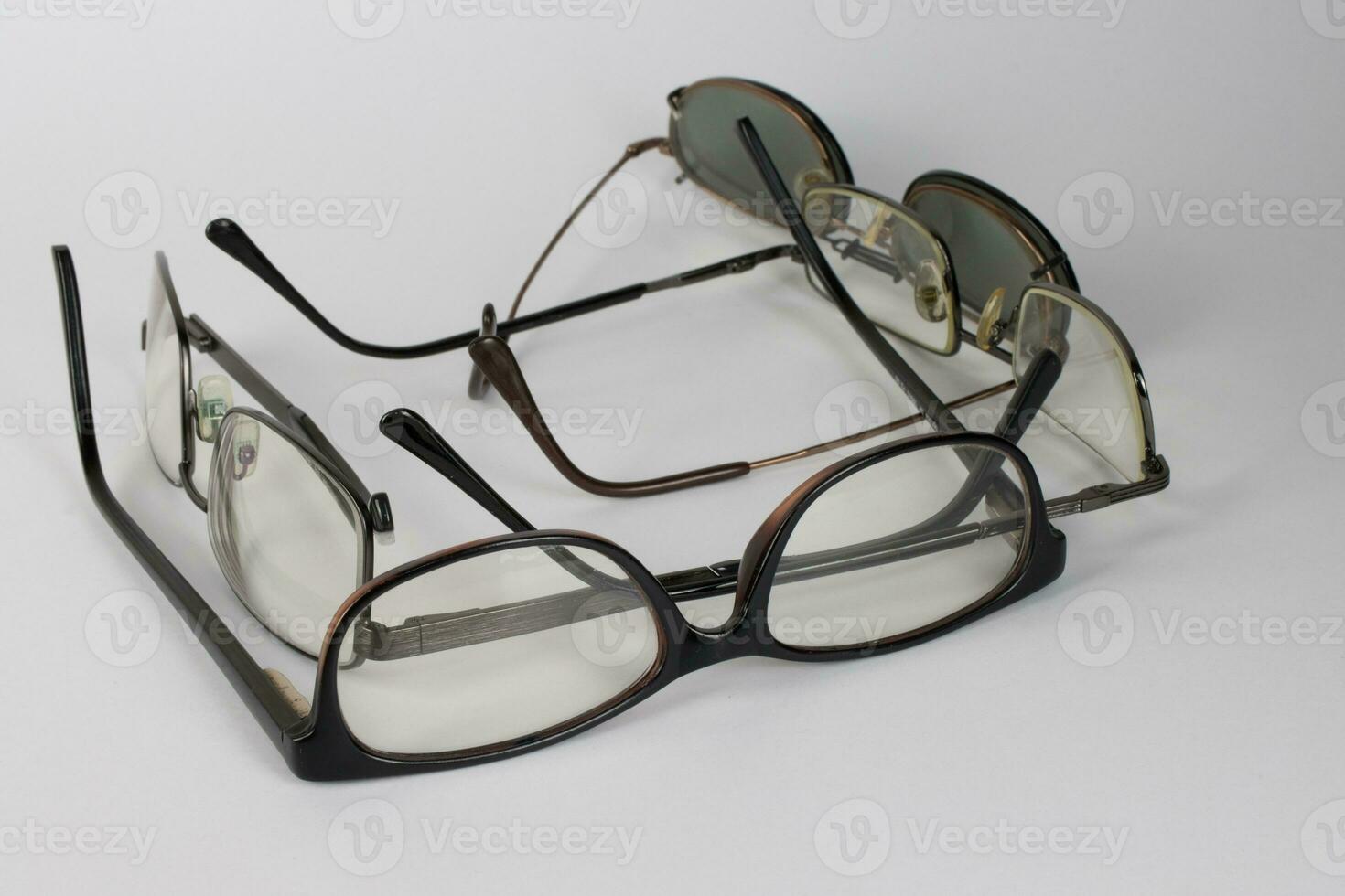 A bunch of old prescription eyeglasses photo